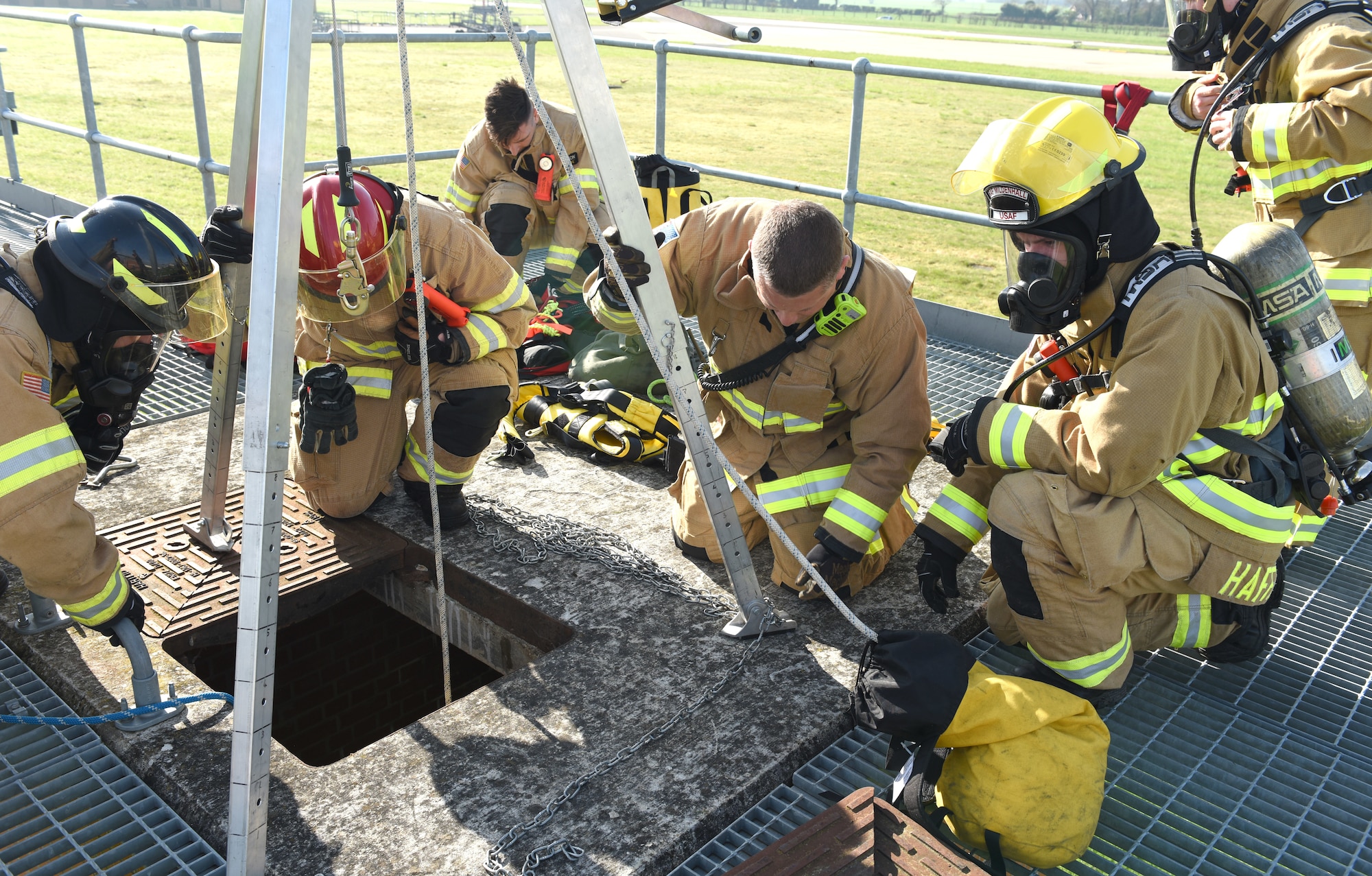 U.S. Air Force and British civilian firefighters, assigned to the 100th Civil Engineer Squadron Fire Department, carry out confined space training at the purpose-built facility at Royal Air Force Mildenhall, England, April 14, 2022.  This type of training is vital to the first responders to provide them with the necessary skills to extricate wounded or trapped personnel, including high-angle litter and stretcher evacuation. (U.S. Air Force photo by Karen Abeyasekere)