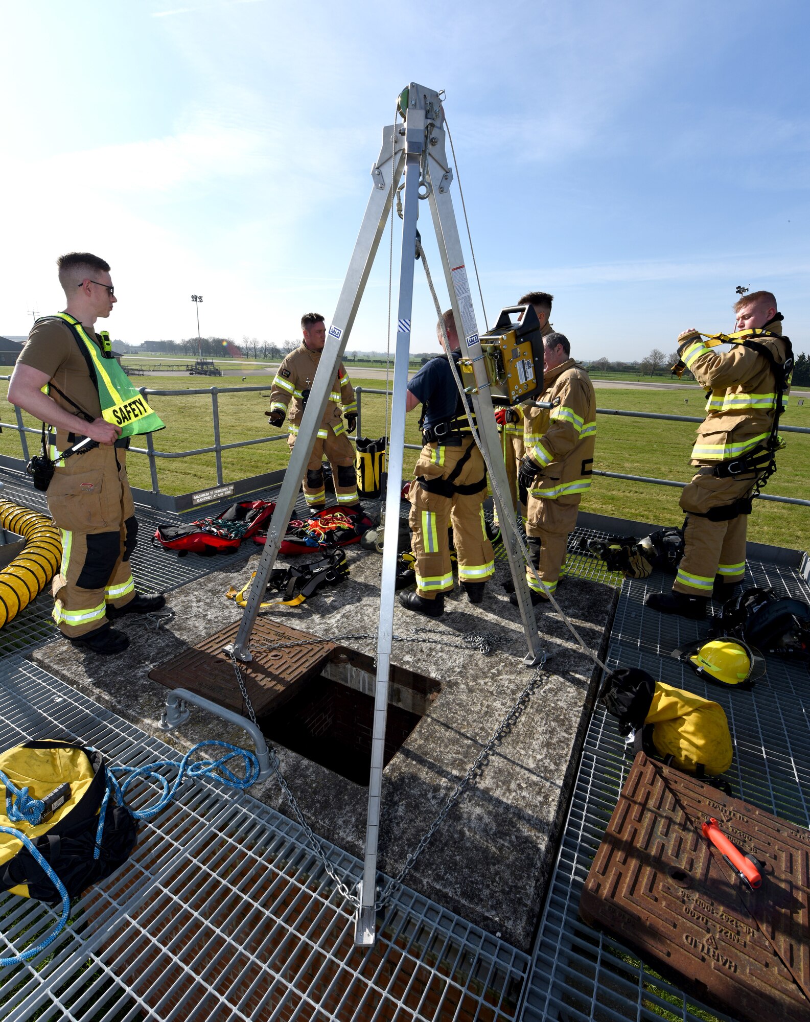 U.S. Air Force and British civilian firefighters, assigned to the 100th Civil Engineer Squadron Fire Department, carry out confined-space training at the purpose-built facility at Royal Air Force Mildenhall, England, April 14, 2022.  The fire department conducts a full confined-space drill at least four times a year for firefighters to meet training requirements. It’s vital for them to stay proficient with confined space and rescue to ensure they can successfully respond to real-world emergencies. (U.S. Air Force photo by Karen Abeyasekere)