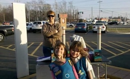 Daisy Girl Scouts and military children sell cookies