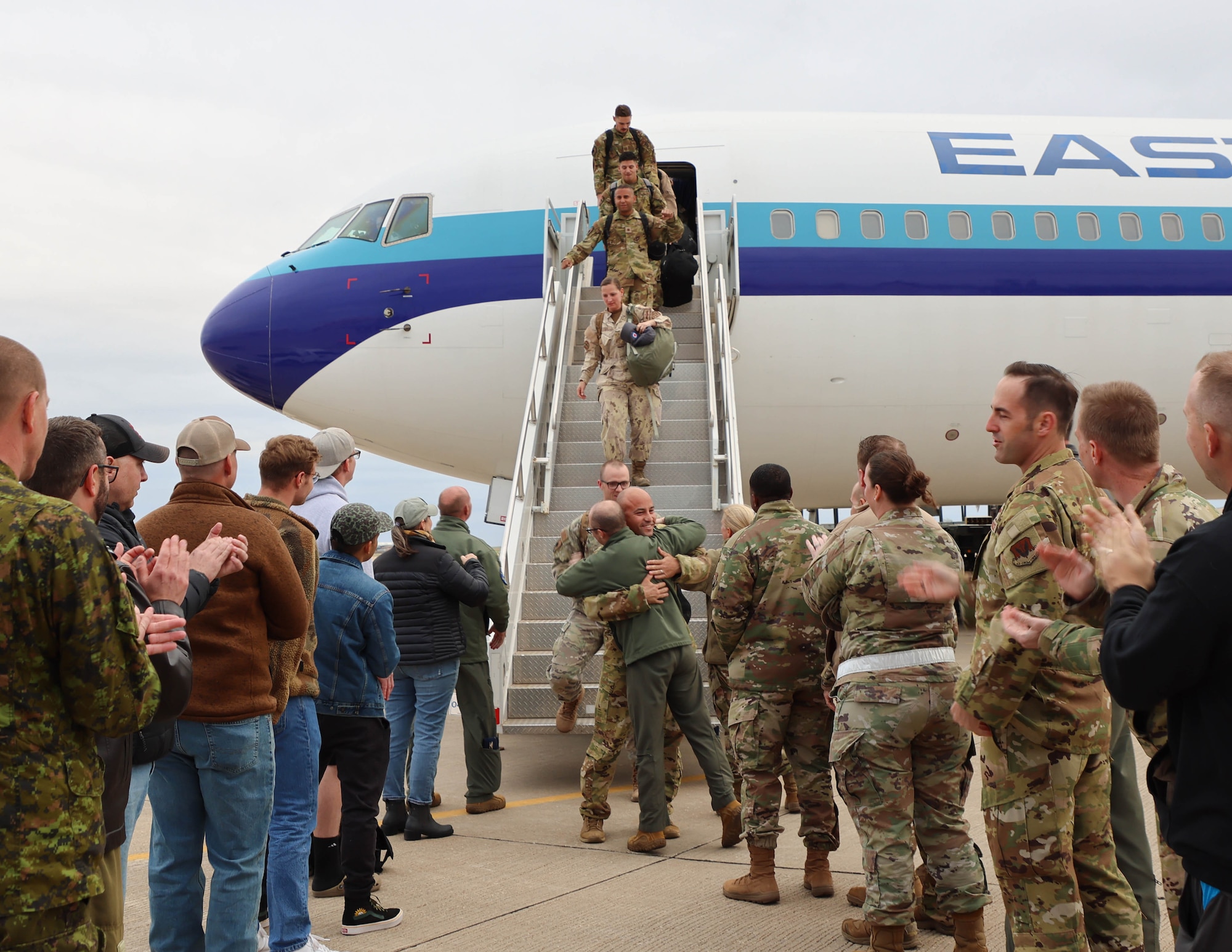 Airmen disembark aircraft upon their return home.