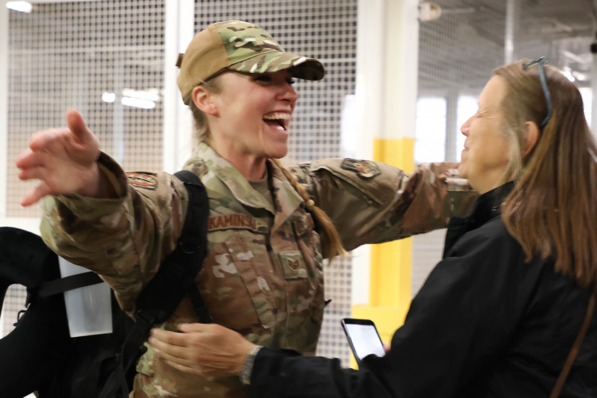 Airman greets relative with a big smile upon returning from deployment.