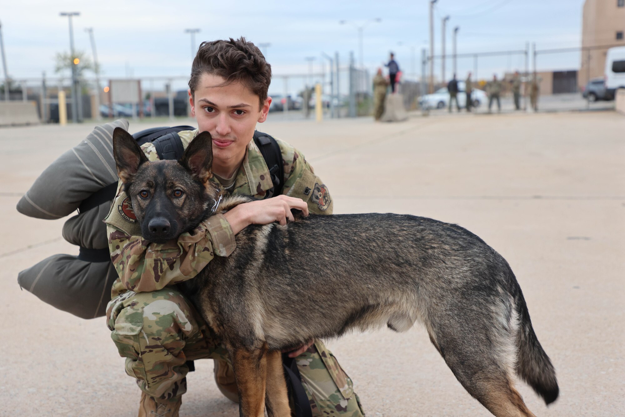 Airman hugs pet dog upon returning from a deployment.