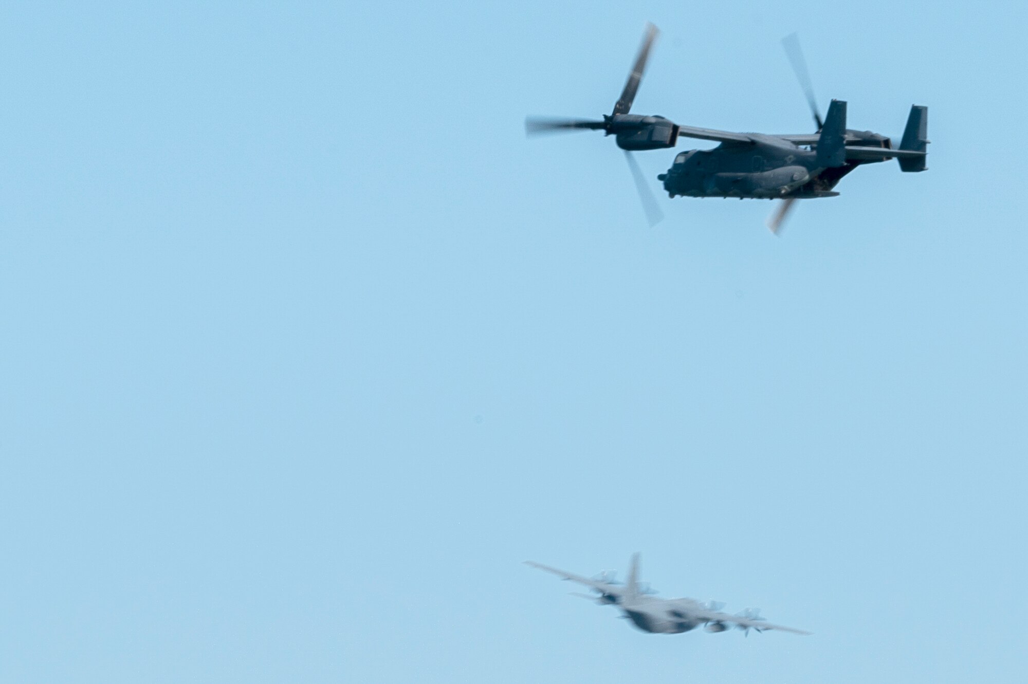 An 8th Special Operations Squadron CV-22 Osprey, assigned to Hurlburt Field, Fla., flies over during The Doolittle Raiders’ 80th Anniversary ceremony, as a 4th Special Operations Squadron AC-130J Ghostrider gunship, also assigned to Hurlburt Field, Fla., flies in the background, April 18, 2022 at Okaloosa Island. More than 14 aircraft including the B-25 medium bombers, which participated in the Doolittle Raid, conducted an aerial review over Okaloosa Island, Florida following a formal ceremony honoring participants of the air operation.