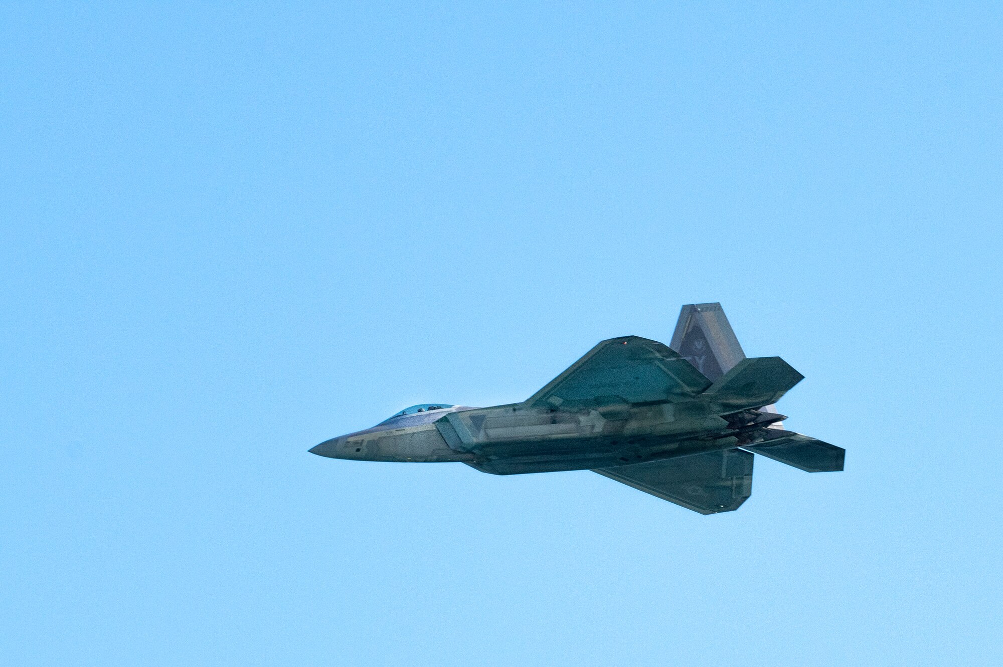 An F-22 Raptor assigned to 43d Fighter Squadron, Tyndall AFB, Fla., flies over during The Doolittle Raiders’ 80th Anniversary ceremony, April 18, 2022 at Okaloosa Island. U.S. Air Force Lt. Gen. Jim Slife, commander of Air Force Special Operations Command and U.S. Air Force Lt. Gen. Brad Webb, commander of Air Education and Training Command (AETC), conducted an aerial review in honor of the members of the Doolittle Raiders.