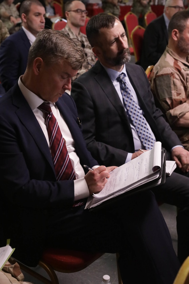 Global Coalition ambassadors and attendees take notes during the Ambassadors Day event at Union III forward operating base in Baghdad, Iraq, April 21, 2022. During the CJTF-OIR-hosted event, representatives from more than 25 Coalition countries discussed the CJTF-OIR mission and broad efforts to tackle enduring regional security and stability challenges. (U.S. Army photo by Spc. Nathan Smith)