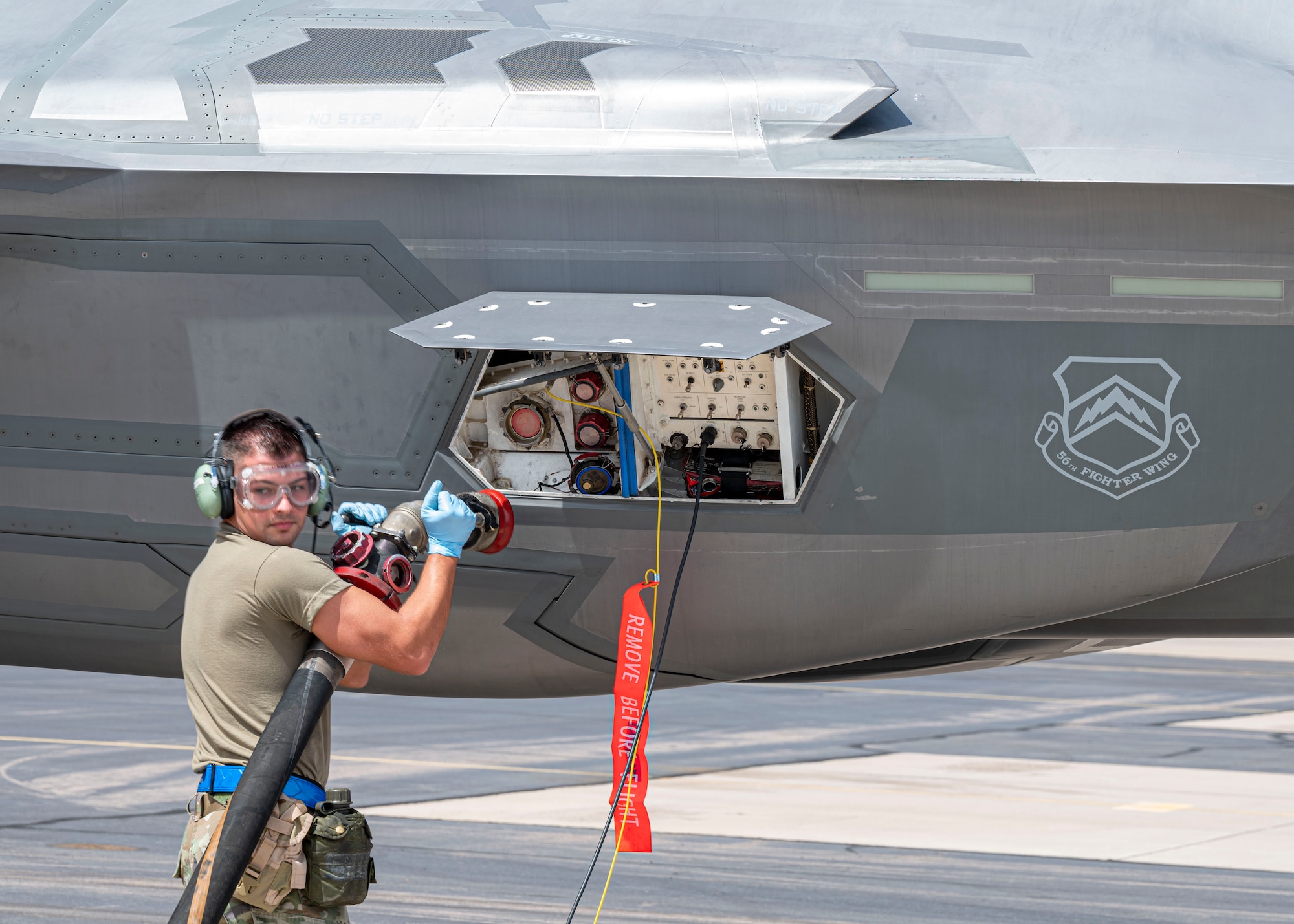 U.S. Air Force Tech. Sgt. Casey O’Neal, 944th Aircraft Maintenance Squadron crew chief, hooks the fuel hose from an R-11 Refueling Vehicle to an F-35A Lightning II aircraft assigned to the 56th Fighter Wing, during an Agile Combat Employment multi-capable exercise, March 31, 2022, at Gila Bend Air Force Auxiliary Field, Gila Bend, Arizona.