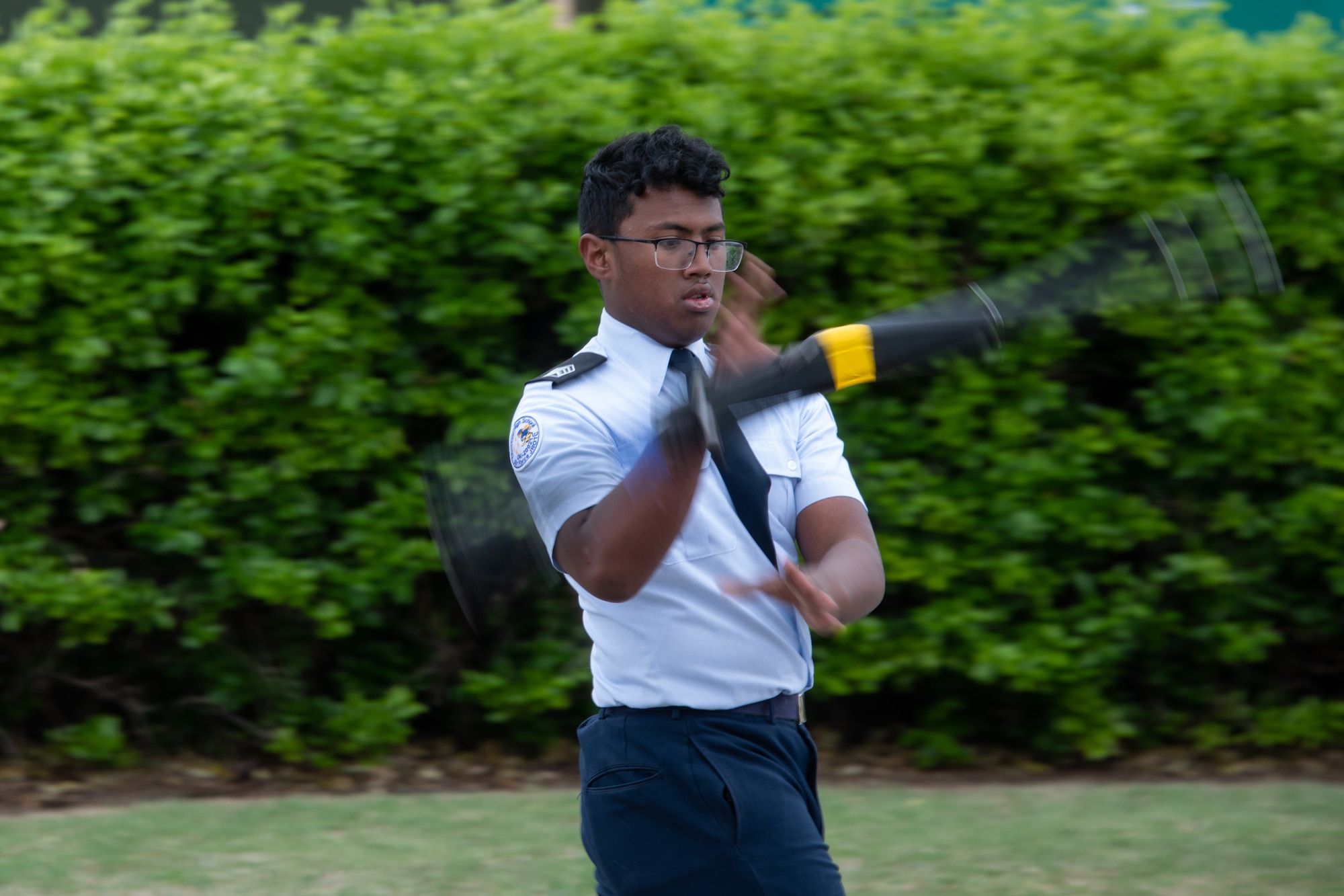 JROTC cadet twirls drill rifle