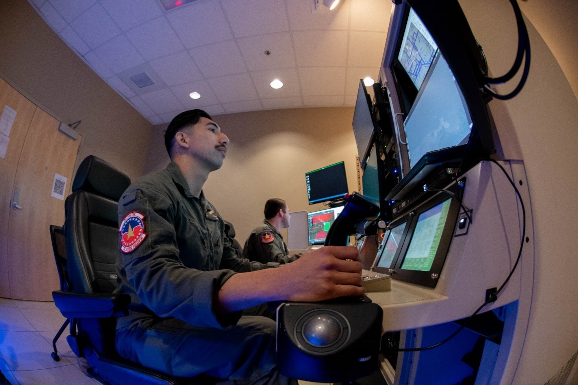 Pilot and sensor operator fly an MQ-9 simulator for Reaper Smoke.