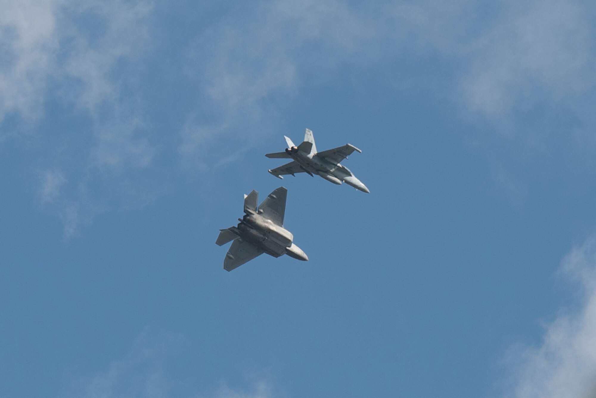 A Hawaii Air National Guard F-22 Raptor and a Navy Reserve VAQ-209 EA-18G Growler execute combat air-to-air exercises Jan. 21, 2022 Joint Base Pearl Harbor-Hickam, Hawaii. The exercise is held to provide participants a multi-faceted, joint venue with supporting infrastructure and personnel.