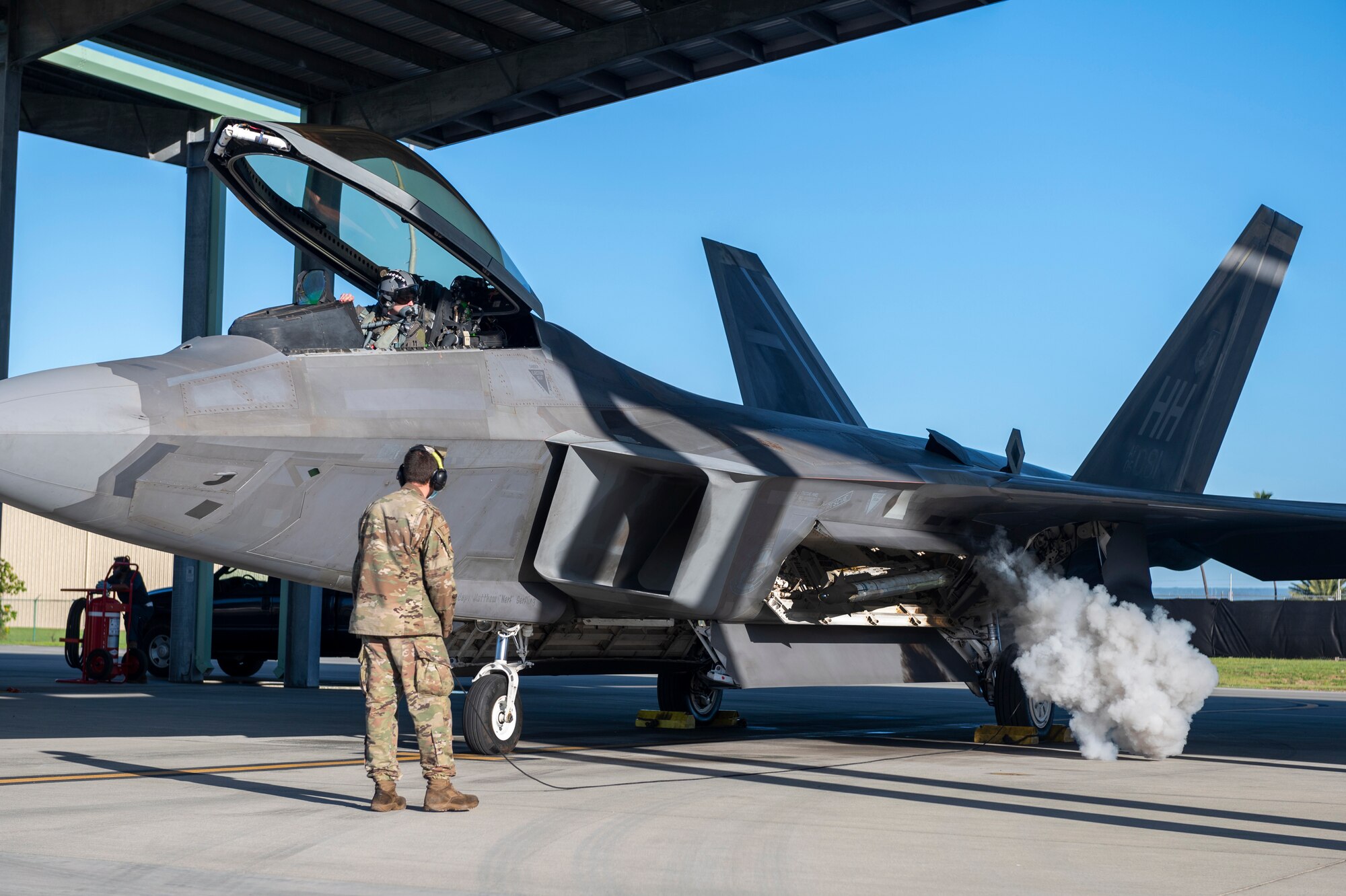 A Total Force F-22 Raptor pilot conducts a preflight check on the auxiliary power unit during a joint exercise Jan. 21, 2022, at Joint Base Pearl Harbor-Hickam, Hawaii.