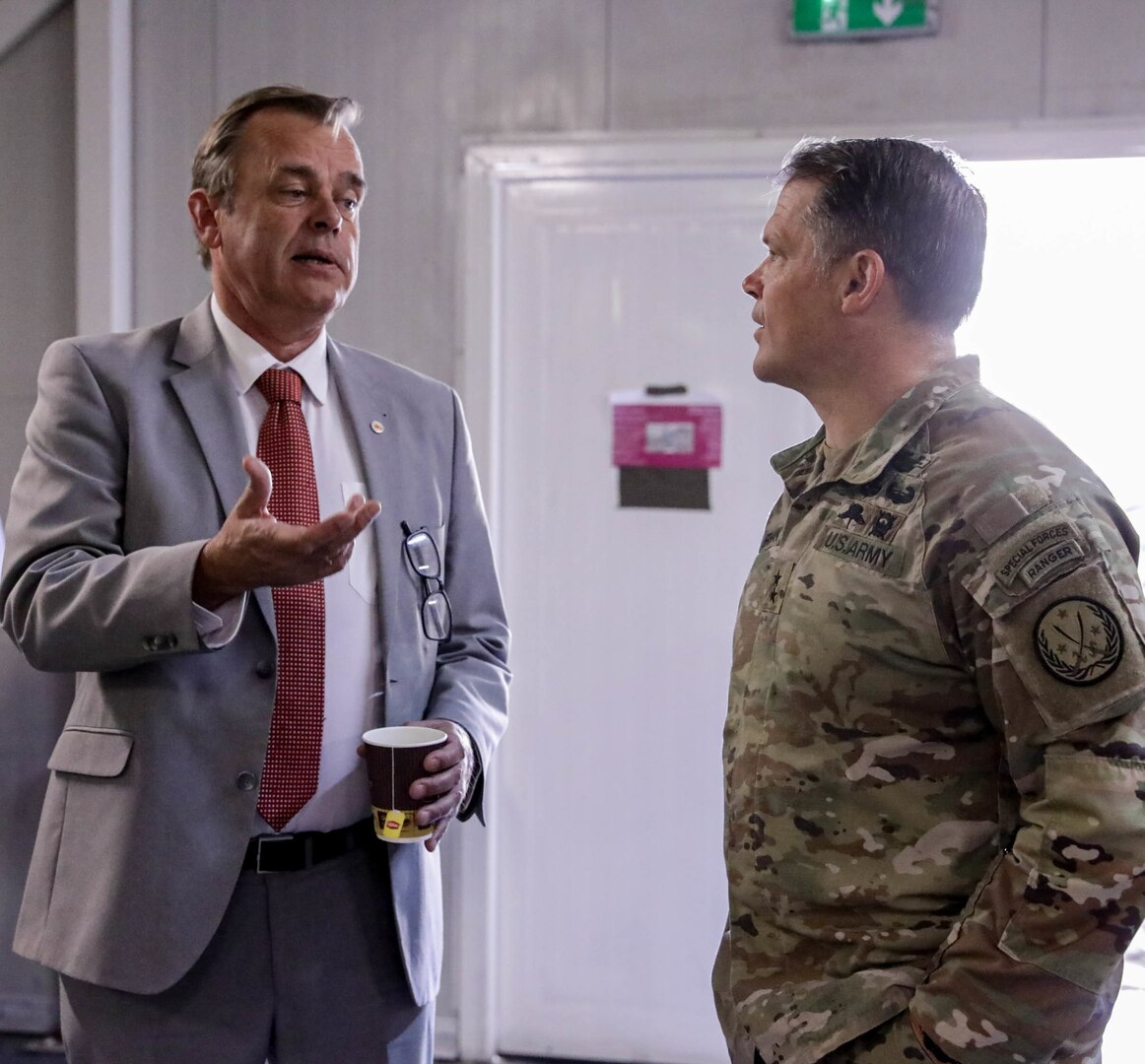 U.S. Army Maj. Gen. John Brennan, Combined Joint Task Force -Operation Inherent Resolve (CJTF-OIR) commander, right, and Michel Rentenaar, the Netherlands Ambassador to Iraq, hold a conversation at the Ambassadors Day event at Union III forward operating base in Baghdad, Iraq, April 21, 2022. During the CJTF-OIR-hosted event, representatives from more than 25 Coalition countries discussed the CJTF-OIR mission and broad efforts to tackle enduring regional security and stability challenges. (U.S Army photo by Spc. Nathan Smith)