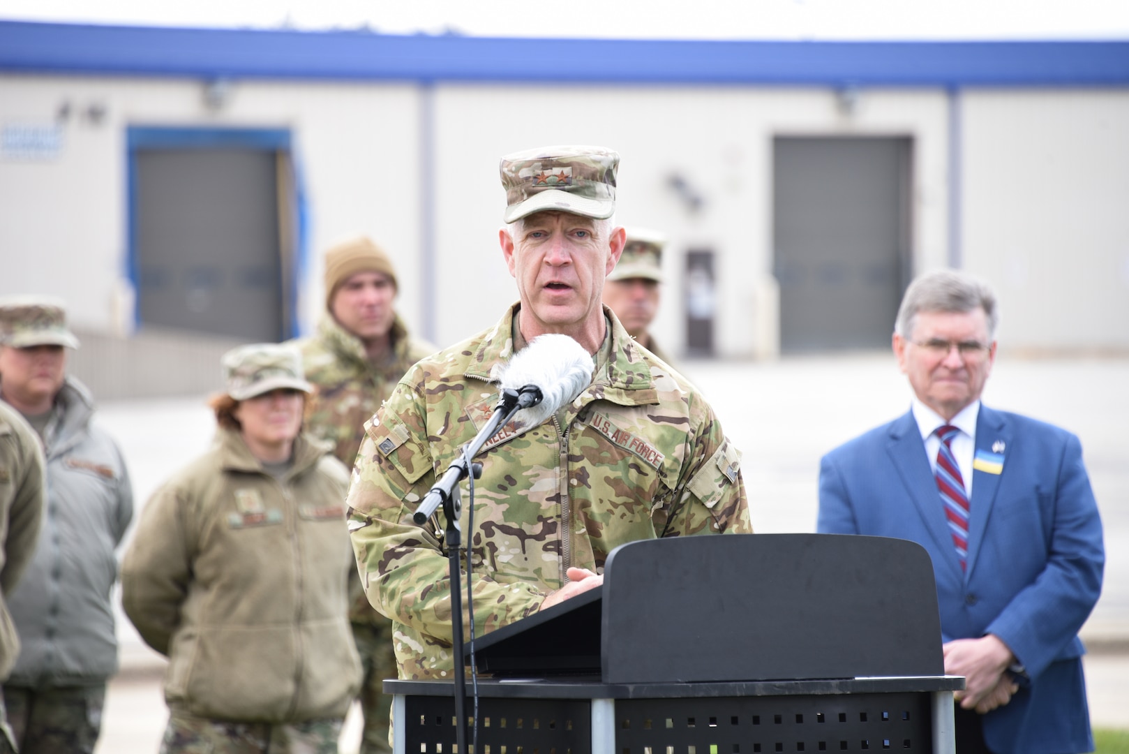 Photo of Maj General Neely (TAG-Illinois) speaking at podium outdoors