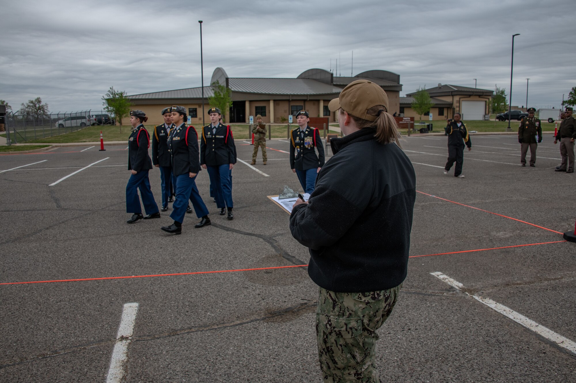 navy judge observes marching jrotc cadets