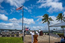 Cmdr. Douglas Pratt, from Nashua, N.H., gives remarks during a change of command ceremony for the Los Angeles-class fast-attack submarine USS Tucson (SSN 770) outside the Pacific Fleet Submarine Museum in Pearl Harbor, Hawaii, April 19, 2022.