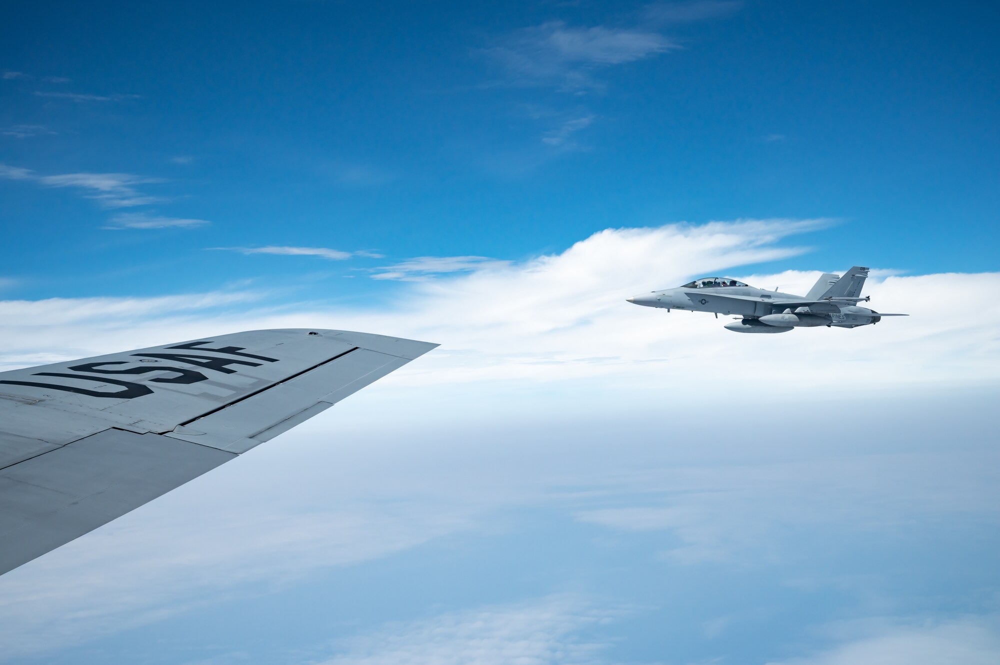 aircraft flying next to another aircraft