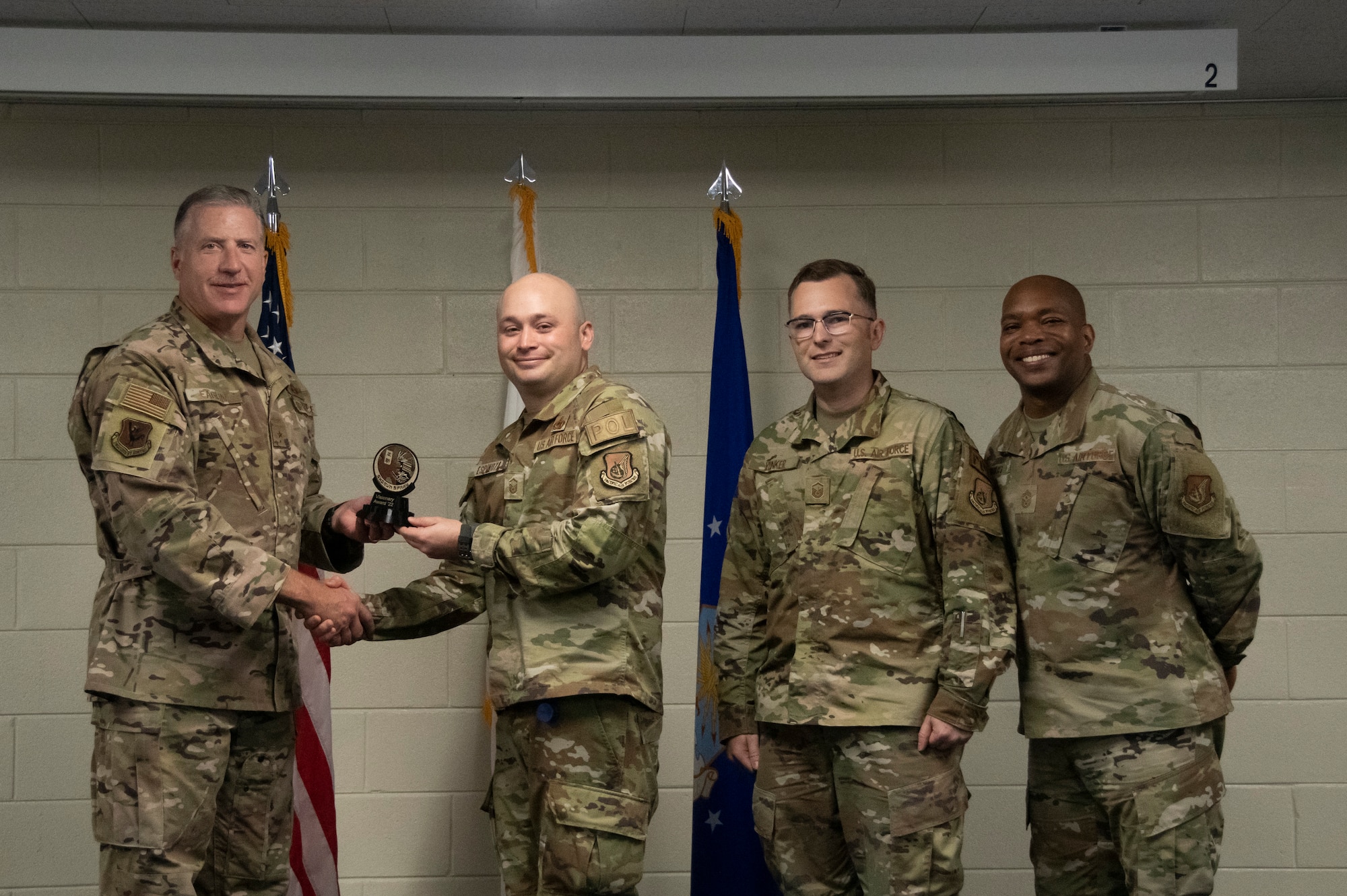 Airmen accept an award.