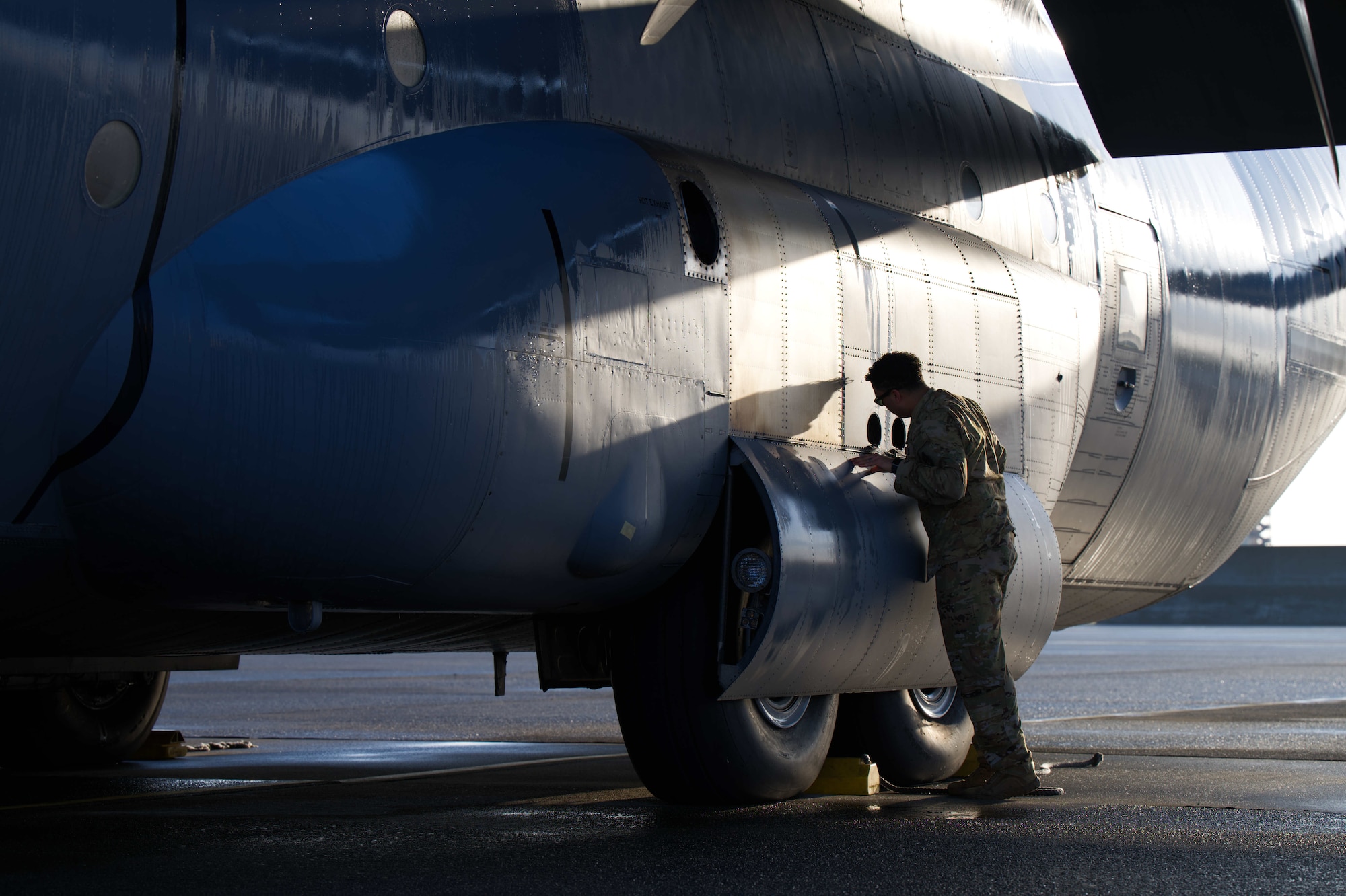 Airman inspects C-130J hull.