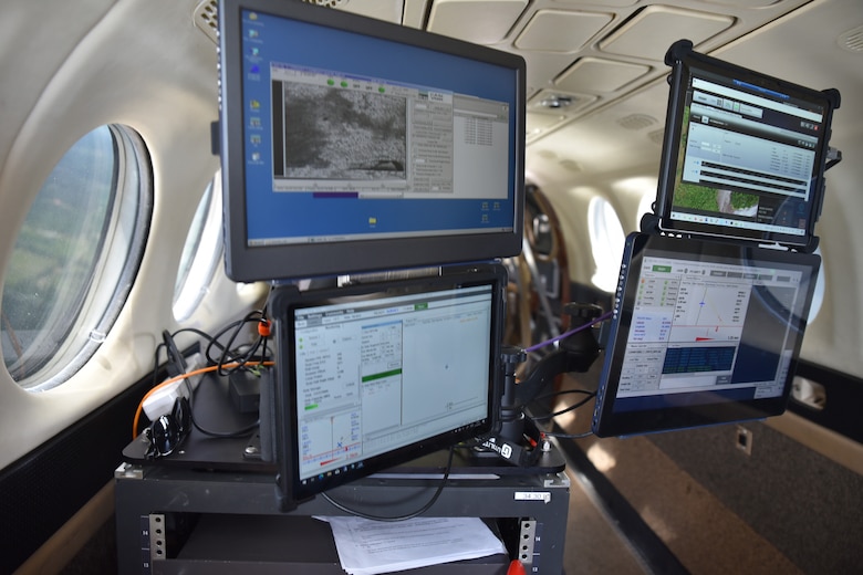 The four monitors display the data gathered from two lidars and two cameras, respectively, during a calibration flight over Stennis International Airport, Mississippi, April 18, 2022. The Joint Airborne Lidar Bathymetry Technical Center of Expertise team collects information about the waterways and coastline to ensure U.S. Army Corps of Engineers’ project success and completion. (USACE photo by Christopher Carranza)
