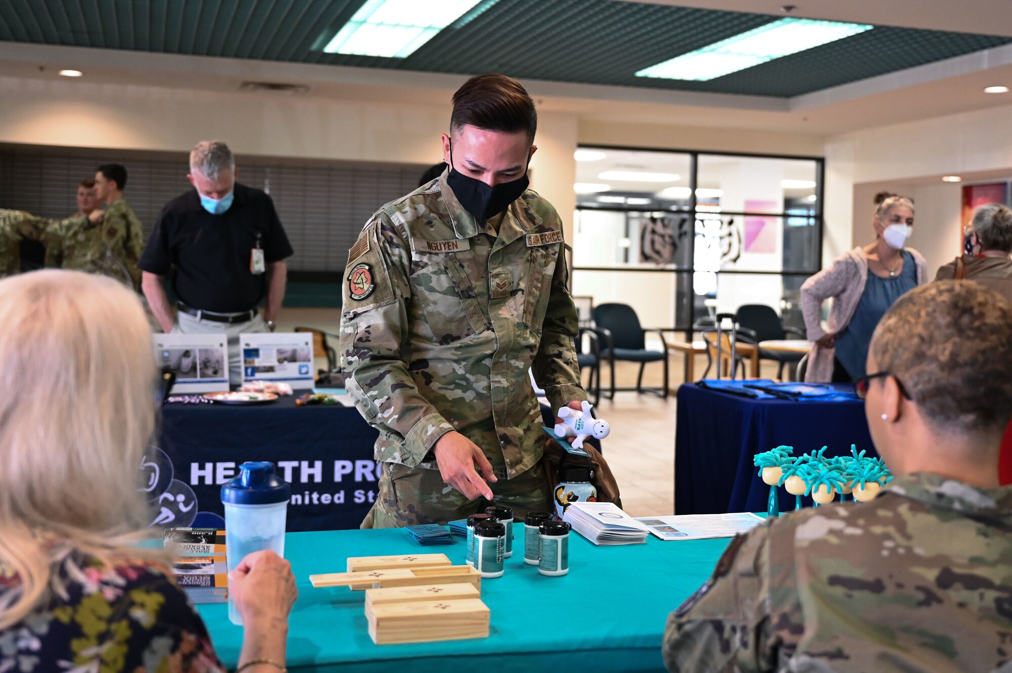 A man reaches for something on a table.
