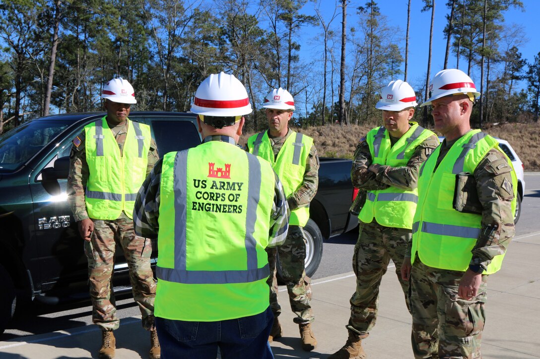 Bryan Tempio, a Resident Engineer with the U.S. Army Corps of Engineers Charleston District, speaks to Command Sgt. Maj. Philson Tavernier (left), command sergeant major for Fort Jackson, Command Sgt. Maj. Travis Wirth, command sergeant major for the 193rd Infantry Brigade, Command Sgt. Maj. Roberto Guadarrama, command sergeant major for the 165th Infantry Brigade and Command Sgt. Maj. Chad Blansett (right), command sergeant major for the U.S. Army Corps of Engineers South Atlantic Division, prior to visiting the Basic Training Complex Four, Phase Two worksite at Fort Jackson. Blansett came to Fort Jackson for the day to see the progress of various construction projects around the base and to meet with the other command sergeants major.
