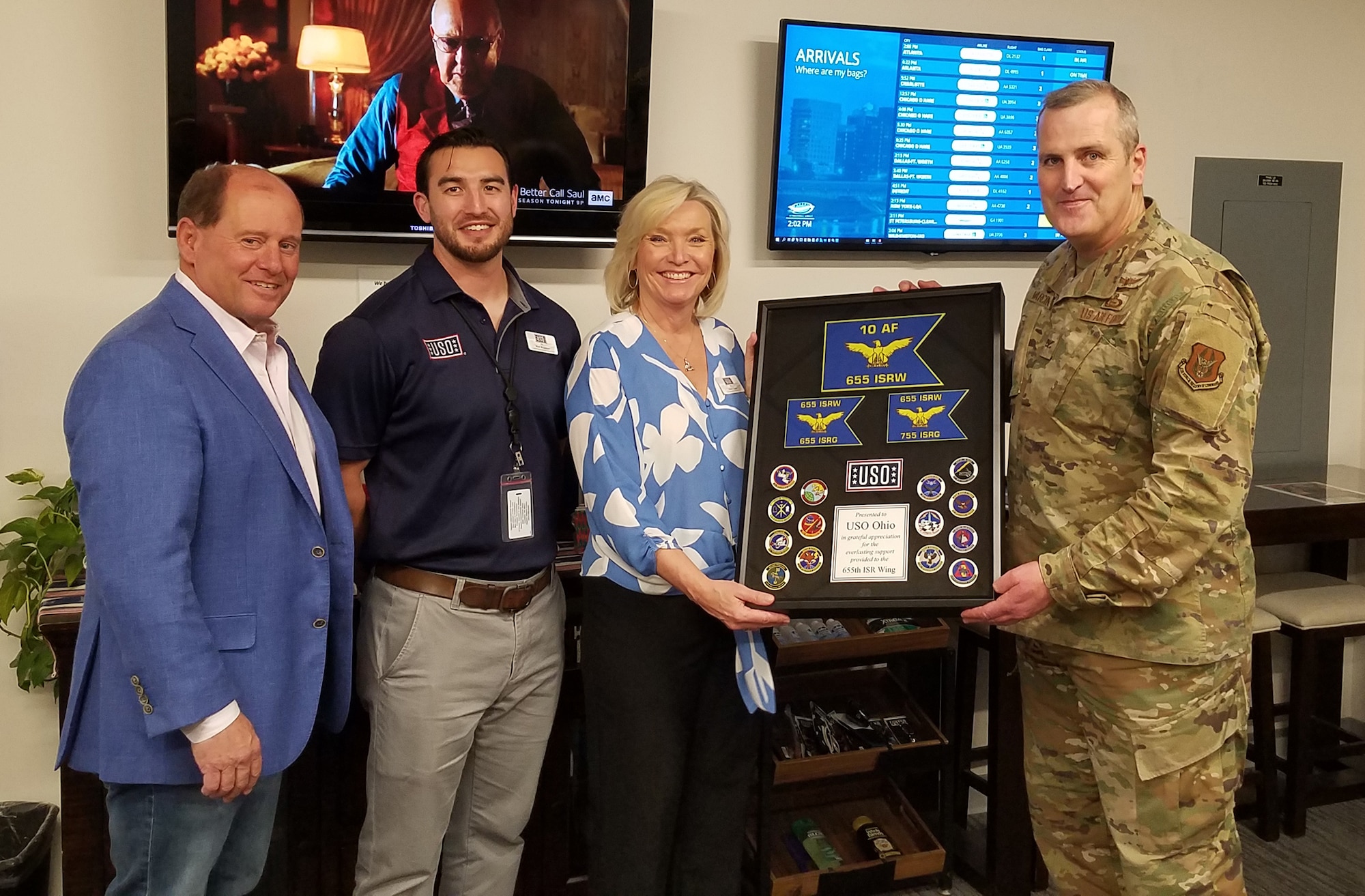 Col. Joseph Marcinek, 655th Intelligence, Surveillance and Reconnaissance (ISR) Wing commander, presents a token of appreciation to the United Service Organizations (USO) Ohio at the USO Dayton-Vandalia Lounge inside the Dayton International Airport April 18, 2022. On hand to accept the gift was USO Ohio Executive Director Sherry Ems. Ems had the USO airport lounge manager, Matt Bradshaw, and USO Ohio board member, Kevin Duffin, accept the gift with her.