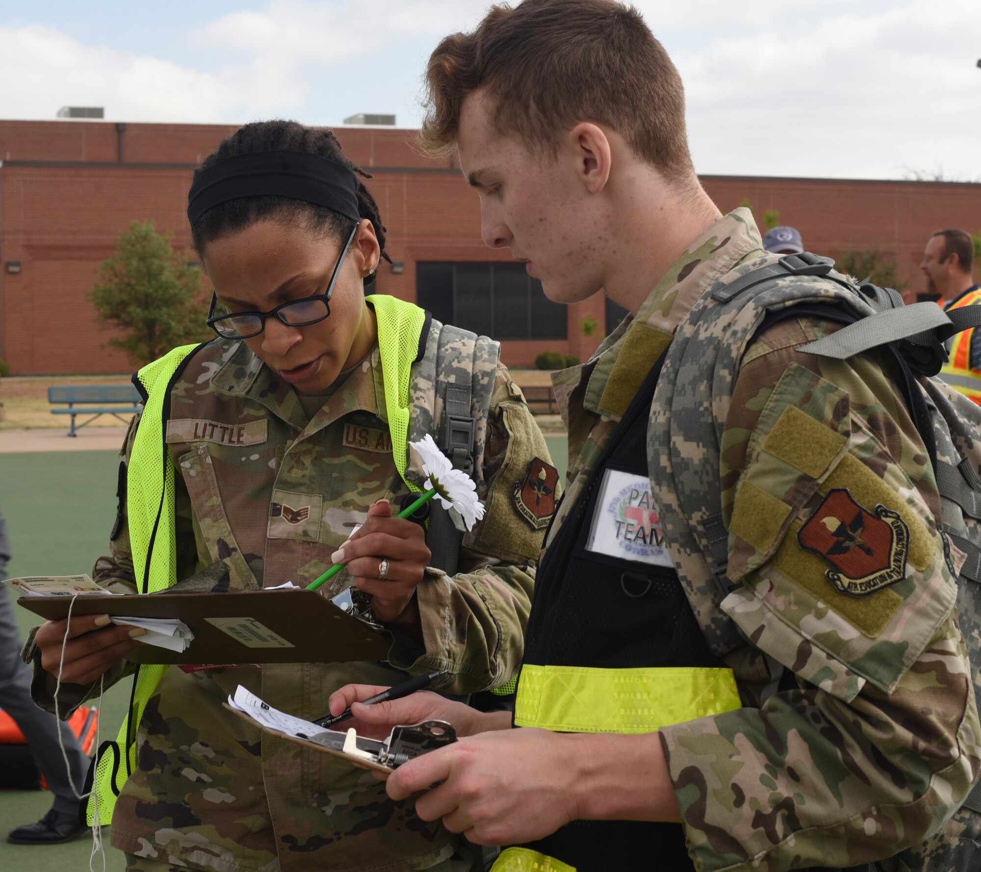 Service members assigned to the 17th Medical Group discuss a simulated victim count during an active shooter exercise at Goodfellow Air Force Base, Texas, April 21, 2022. The victim count was then released to the emergency operations center for commanders to make strategic crisis management decisions. (U.S. Air Force photo by Senior Airman Abbey Rieves)