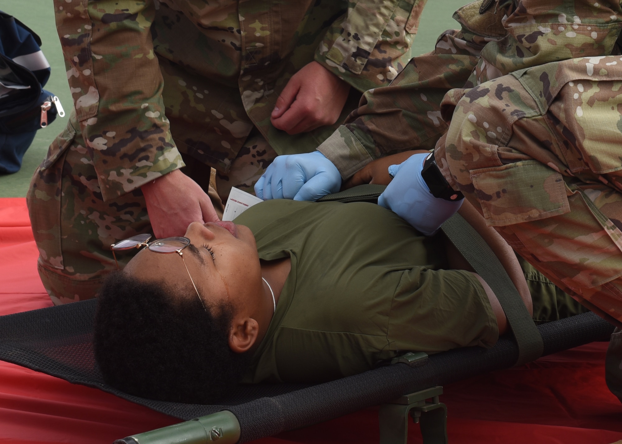 A simulated victim of an active shooter cries during an active shooter exercise at Goodfellow Air Force Base, Texas, April 21, 2022. The actor cried to create extra stress and realism, to test the emergency responder’s crisis capabilities.  (U.S. Air Force photo by Senior Airman Abbey Rieves)