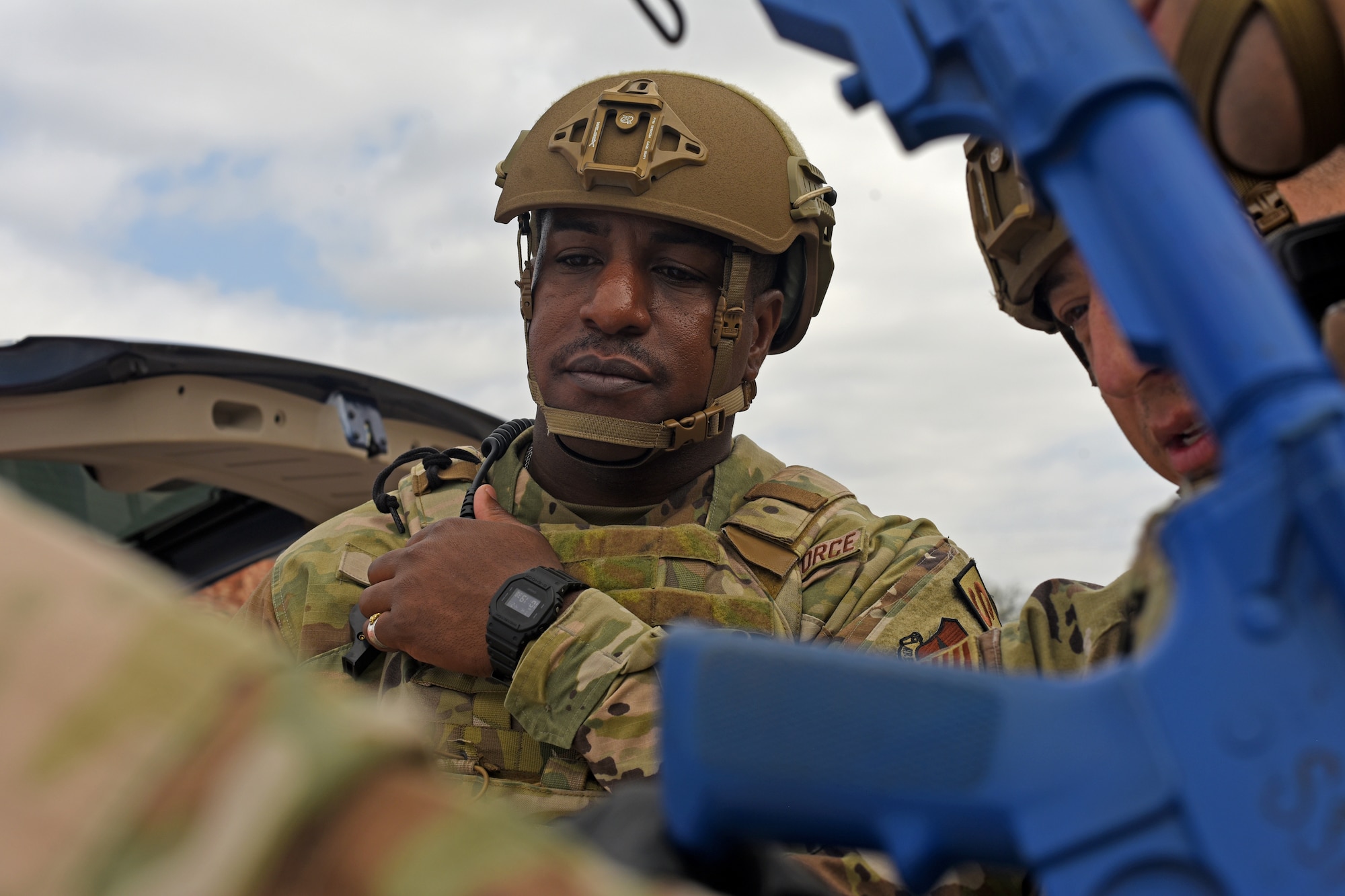 U.S. Air Force Senior Master Sgt. Jarmaine Thomas, 17th Security Forces Squadron operations superintendent, coordinates scene safety during an active shooter exercise at Goodfellow Air Force Base, Texas, April 21, 2022. Thomas reviewed a base map to verify defender patrol parameters encompass the entire scene of the exercise. (U.S. Air Force photo by Senior Airman Abbey Rieves)