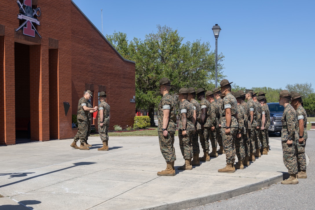 U.S. Marine Corps Staff Sgt. David Jarvis, drill instructor, Marine Corps Recruit Depot Parris Island (MCRD PI), is presented a Noncommissioned Officer of the Year Award and a Navy Achievement Medal by Brig. Gen. Andrew M. Niebel, commanding general, Marine Corps Installations East, at MCRD PI, South Carolina, April 19, 2022. Jarvis was given these awards for performing life saving steps on a Marine and for being a platoon sergeant, a Lance Cpl. seminar instructor, volunteering at Habitat for Humanity and Devil Pups while serving with Headquarters and Headquarters Squadron, Marine Corps Air Station Beaufort. (U.S. Marine Corps photo by Lance Cpl. Nathan Saucier)