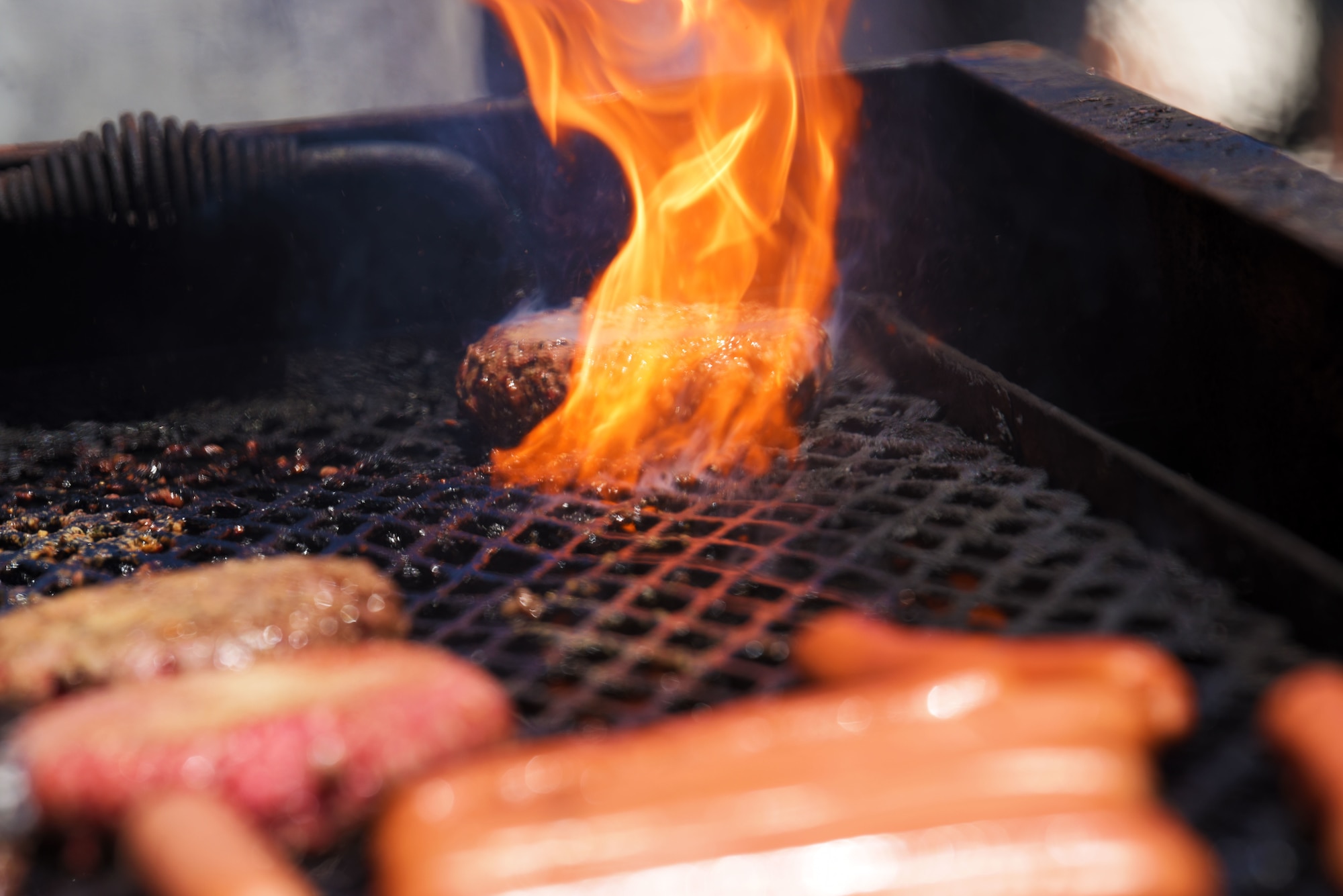 Hamburgers and hotdogs on a grill