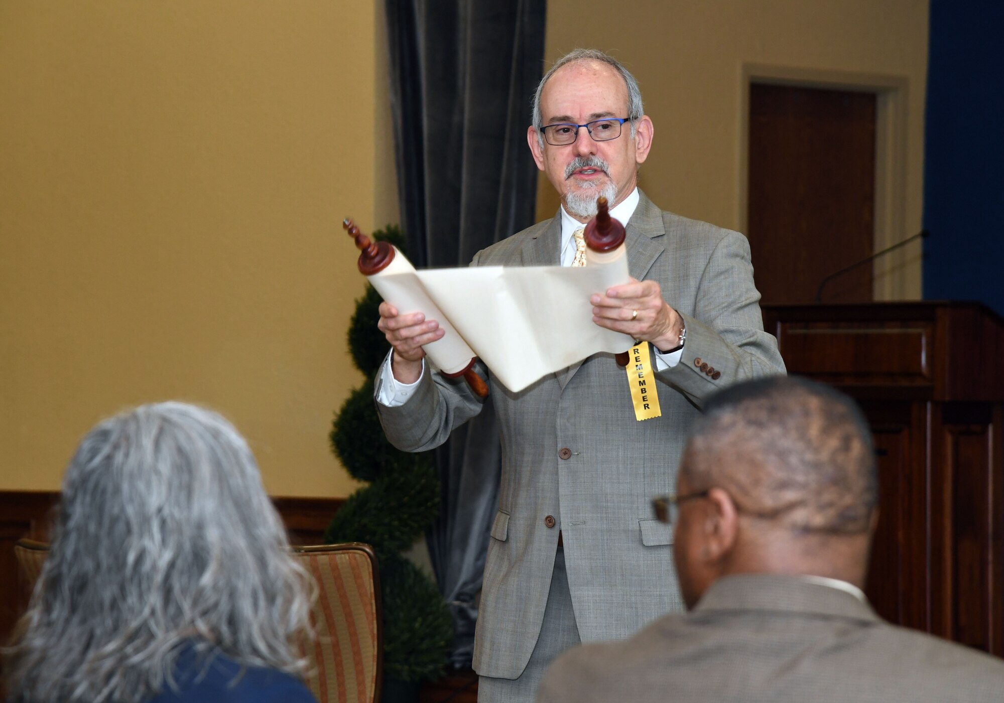Rabbi Steven Silberman, Ahavas Chesed Congregation rabbi, displays a Torah during a Holocaust Remembrance Days of Remembrance event inside the Bay Breeze Event Center at Keesler Air Force Base, Mississippi, April 20, 2022. The event was held in memory of the six million Jewish victims of the Holocaust. (U.S. Air Force photo by Kemberly Groue)