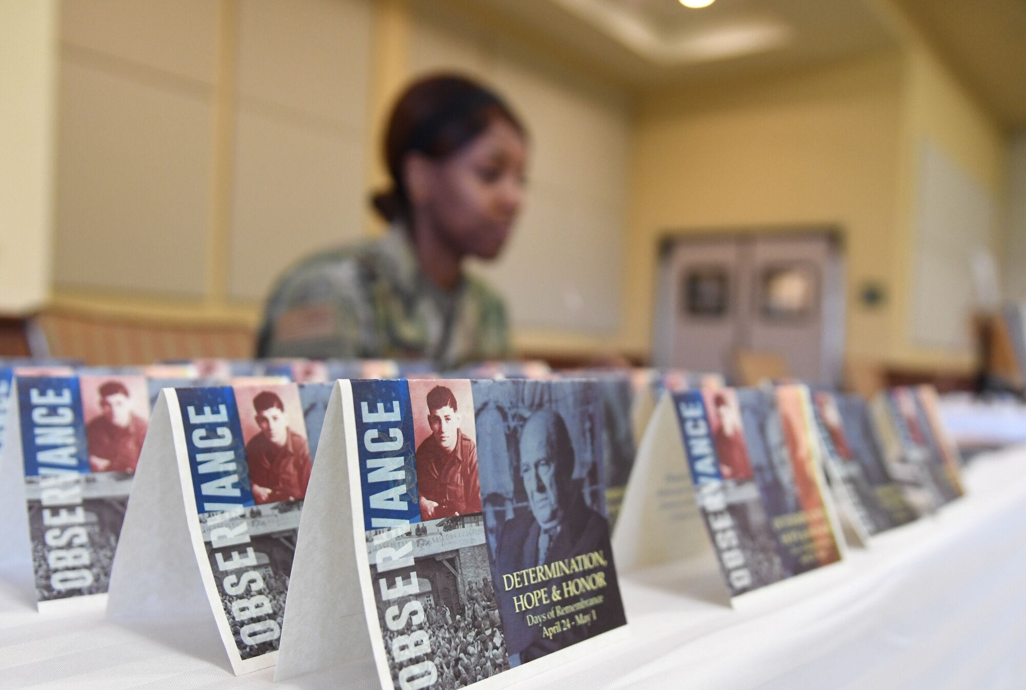 U.S. Air Force Tech. Sgt. Destinee Spates, 81st Dental Squadron residency flight chief, sits behind an information booth during a Holocaust Remembrance Days of Remembrance event inside the Bay Breeze Event Center at Keesler Air Force Base, Mississippi, April 20, 2022. The event was held in memory of the six million Jewish victims of the Holocaust. The panel members also shared their experiences and educational information. (U.S. Air Force photo by Kemberly Groue)