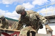 U.S. Army ROTC Cadet Josh Donlon, squad leader with Bucknell University Army ROTC, steadies himself on a wooden beam during a field training exercise at Fort Indiantown Gap, April 8, 2022. Donlan was working with other Soldiers during a group exercise. (U.S. Army National Guard photo by Spc. John Trapani)