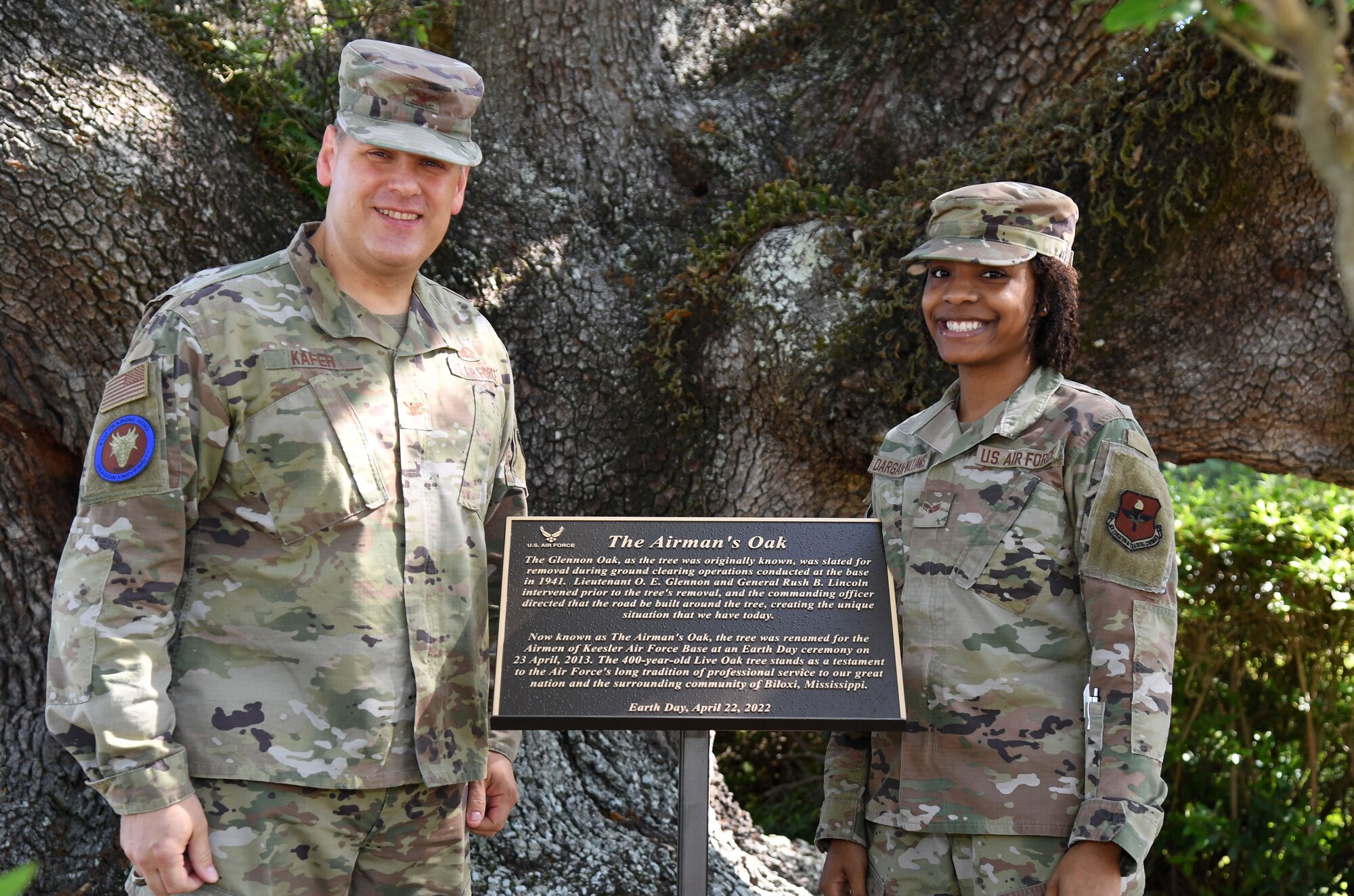U.S. Air Force Col. James Kafer, 81st Training Wing vice commander, and Senior Airman Kaylahn Dargan-Williams, 81st Logistics Readiness Squadron logistics planner, pose for a photo with the Earth Day Airman's Oak Plaque during a ceremony at Keesler Air Force Base, Mississippi, April 22, 2022. The plaque was unveiled during the event to celebrate Earth Day, with this year's theme being “Invest in Our Planet." (U.S. Air Force photo by Kemberly Groue)