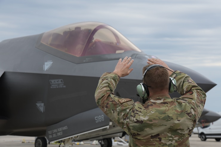 U.S. Air Force Senior Airman Austin Points, 4th Fighter Generation Squadron crew chief, Hill Air Force Base, Utah, marshals an F-35A Lightning II pilot at Tyndall Air Force Base, Florida, March 24, 2022.