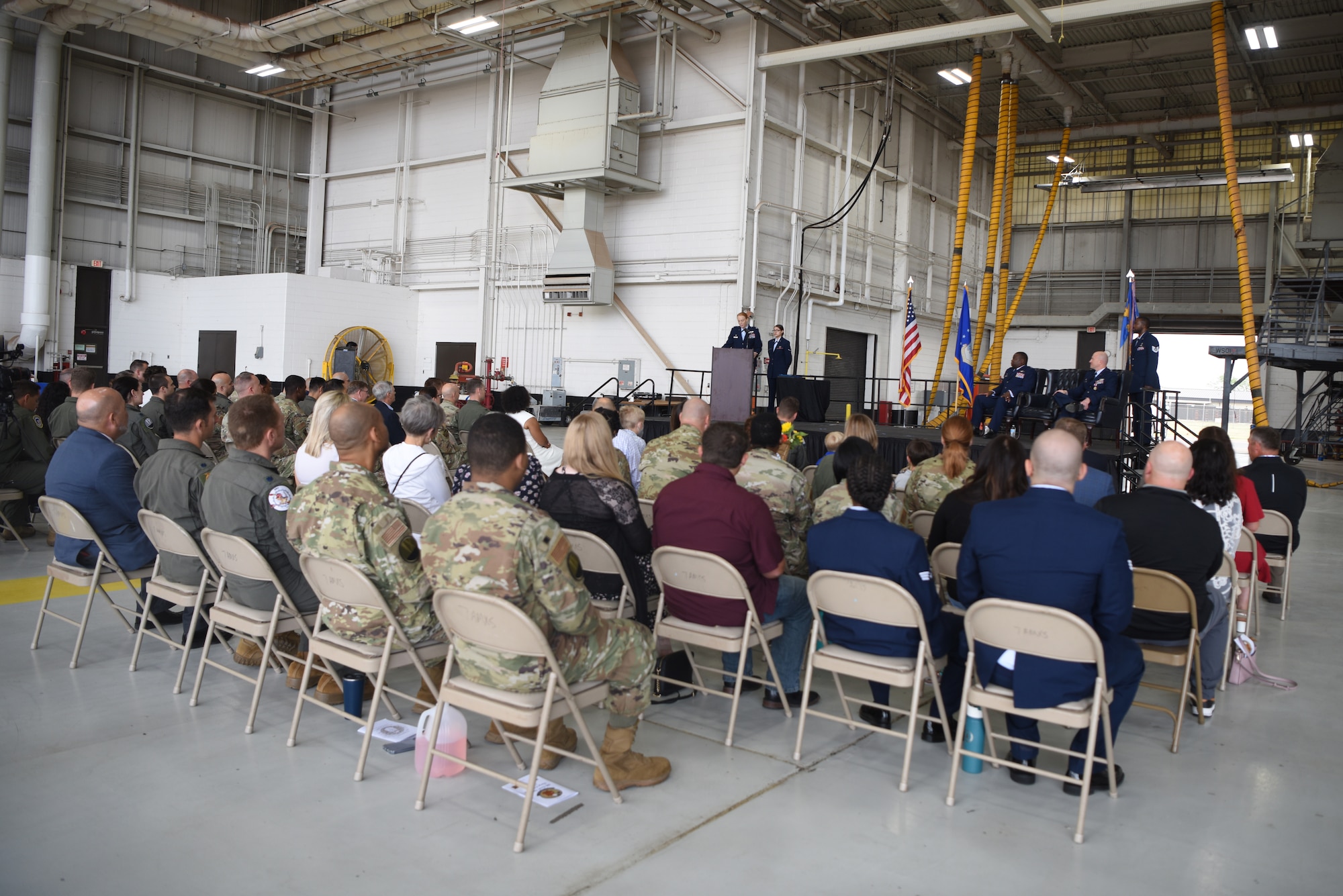 Dyess personnel attend the 28th Bomb Squadron change of command ceremony inside the Three Bay Hangar at Dyess Air Force Base, Texas, April 22, 2022. U.S. Air Force Lt. Col. Scott Thompson relinquished command of the 28th BS to Lt. Col. Kristen Jenkins. As commander, Jenkins will be in charge of determining, evaluating and implementing formal training requirements to qualify crewmembers in long-range day and night, all-weather and air-to-ground attack missions. (U.S. Air Force photo by Staff Sgt. Holly Cook)