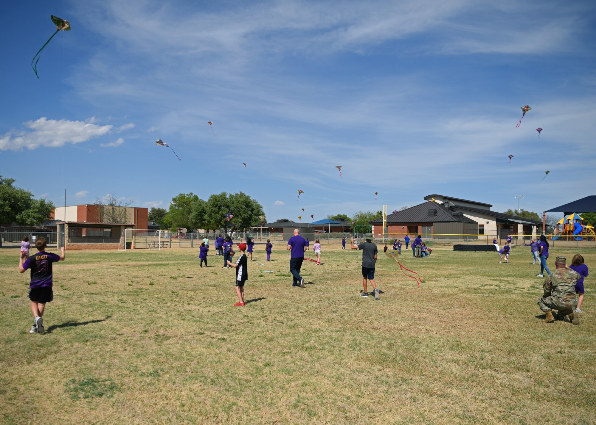 Participants fly their kites in celebration of Month of the Military Child at the School Age Program building, Goodfellow Air Force Base, Texas, April 20, 2022. The kites were flown to celebrate military children and their invaluable support. (U.S. Air Force photo by Senior Airman Ethan Sherwood)