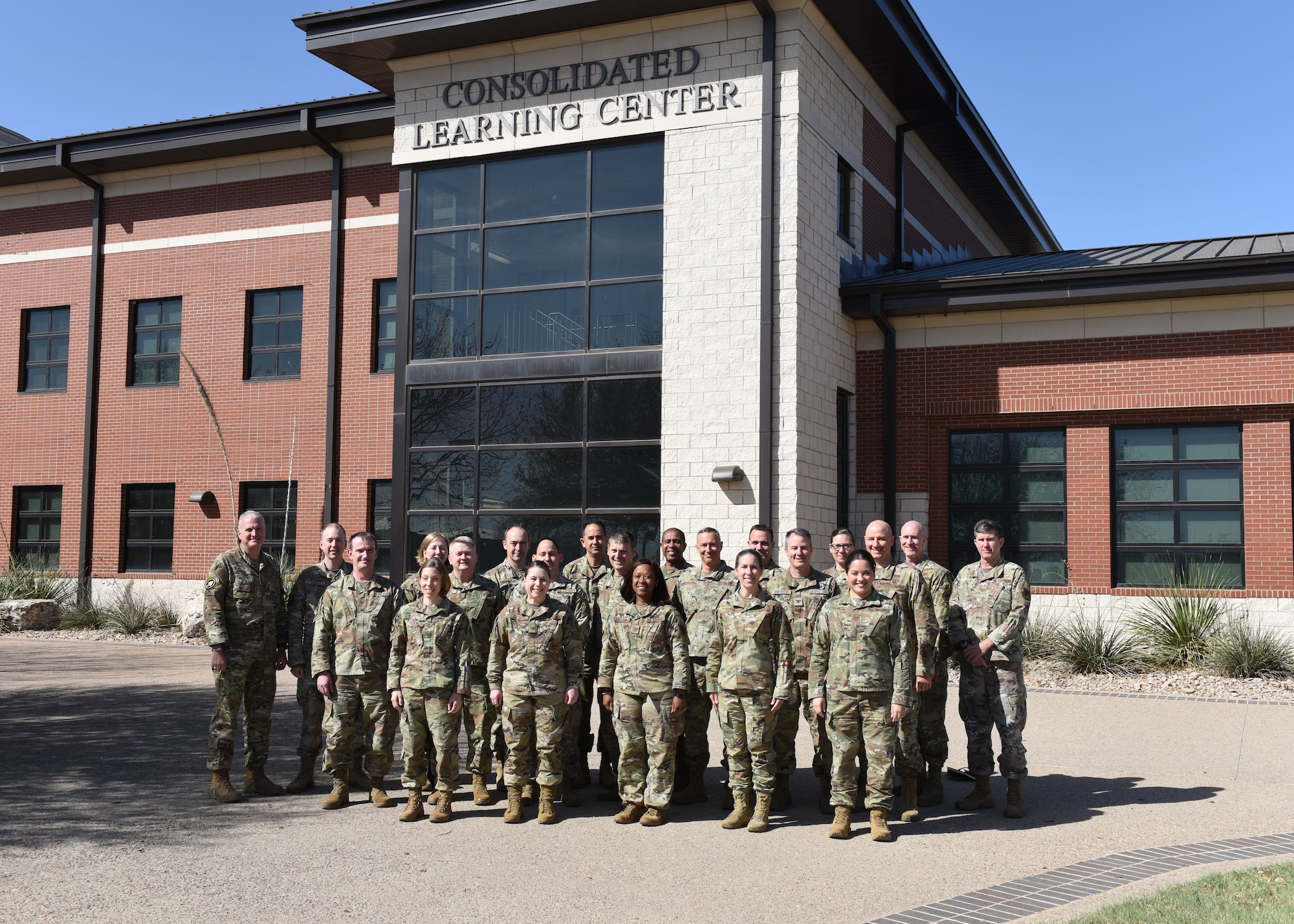 The Intelligence Functional Advisory Team poses with 17th Training Wing leadership in a photo at the Consolidated Learning Center, Goodfellow Air Force Base, Texas, April 14, 2022. The Intelligence FAC is a team who reviews the framework for the Air Force intelligence career field. (U.S. Air Force photo by Airman 1st Class Sarah Williams)