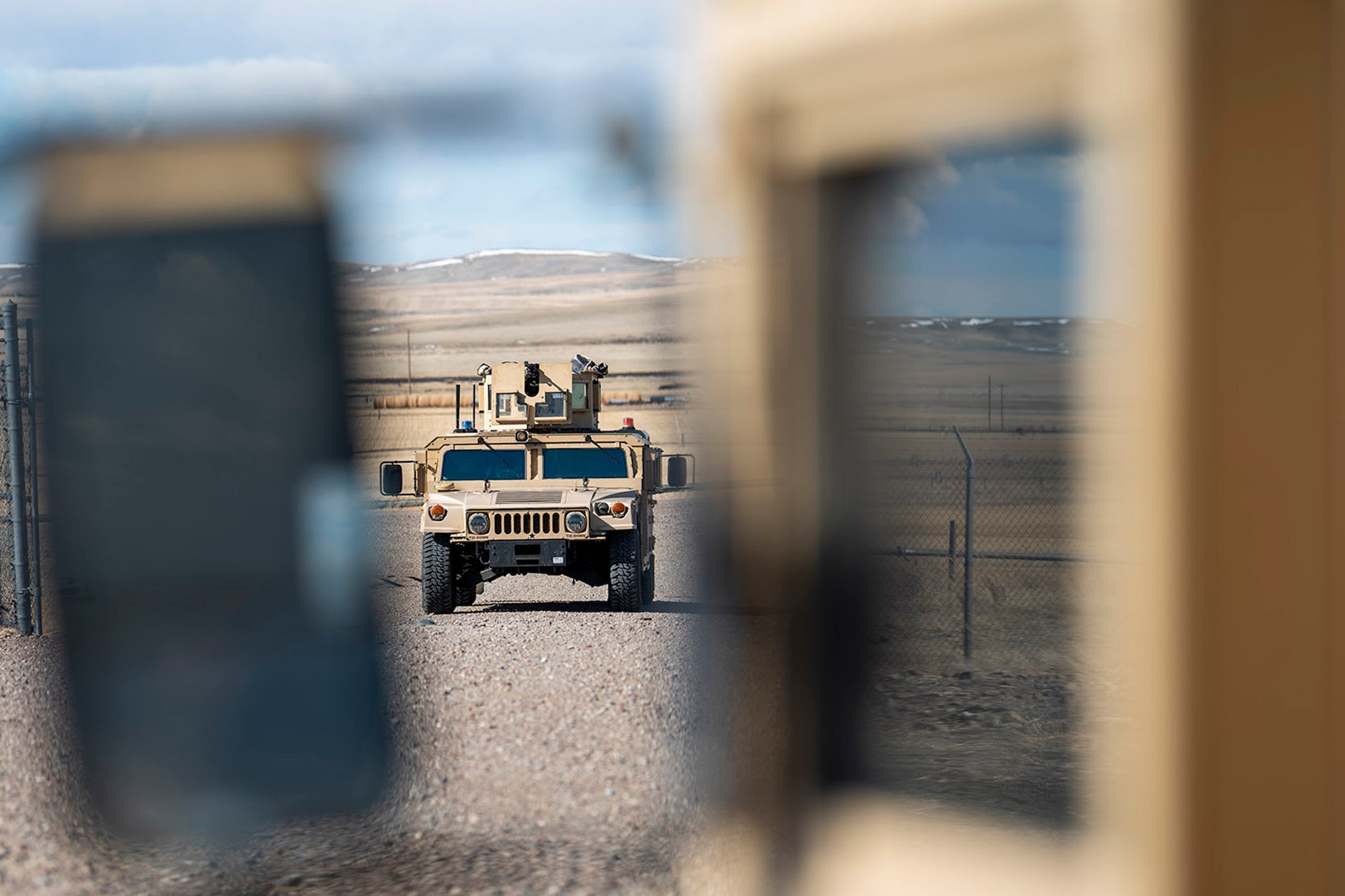A Humvee enters the gates of a missile launch facility during a training exercise April 19, 2022, near Malmstrom Air Force Base, Mont. The Humvee was manned by 841st Missile Security Forces Squadron defenders, who responded to a threat from simulated armed combatants during the training scenario. (U.S. Air Force photo by Airman 1st Class Elijah Van Zandt)