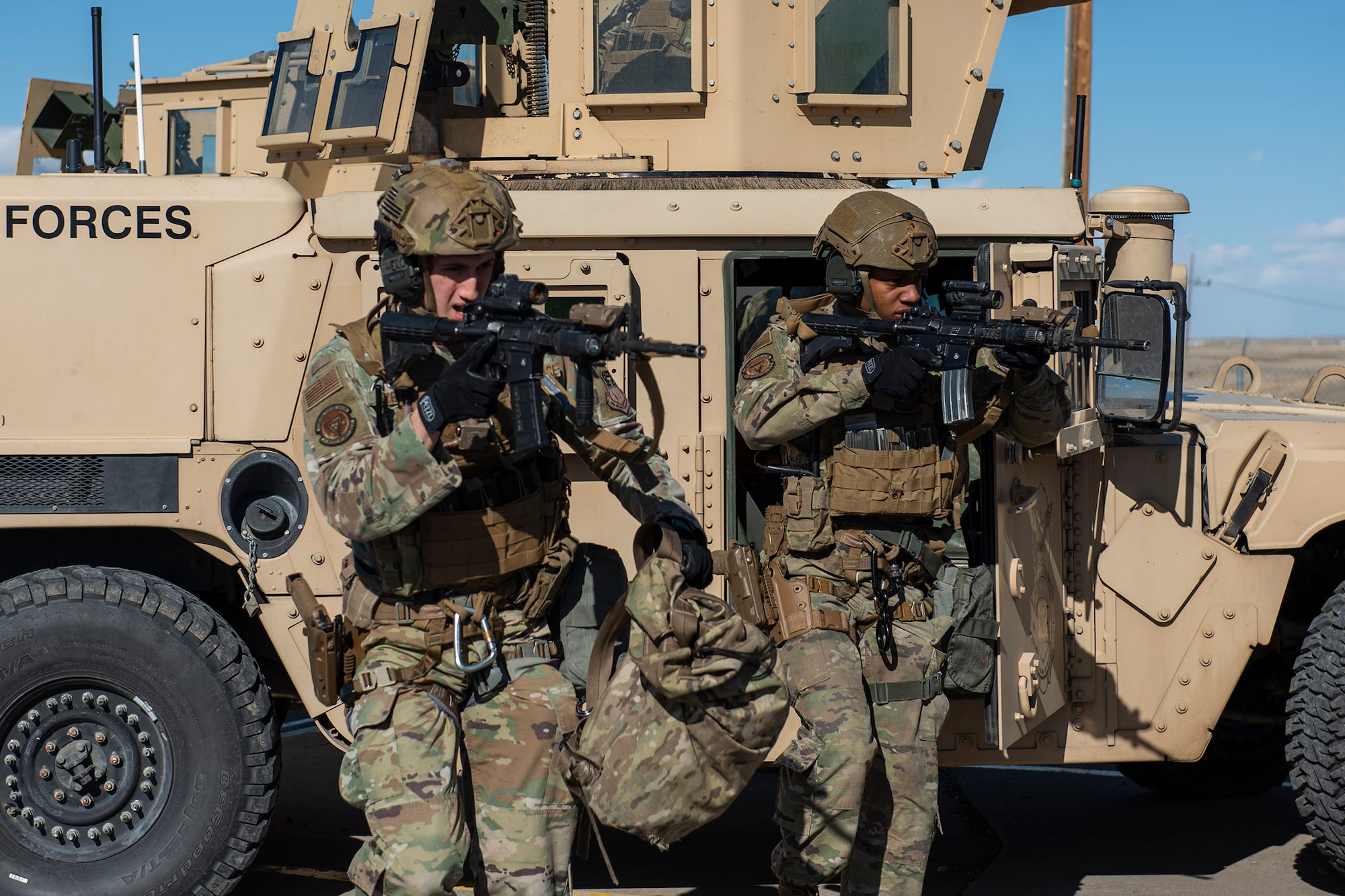 From the left, Airman 1st Class Spencer Riezebos and Senior Airman Jalen Pearson, 341st Missile Security Operation Squadrons tactical response force members, exit a Humvee April 19, 2022, during a training exercise at a launch facility near Malmstrom Air Force Base, Mont. The training exercise tested TRF’s ability to be a lethal and responsive force during emergency situations in the missile field. (U.S. Air Force photo by Airman 1st Class Elijah Van Zandt)