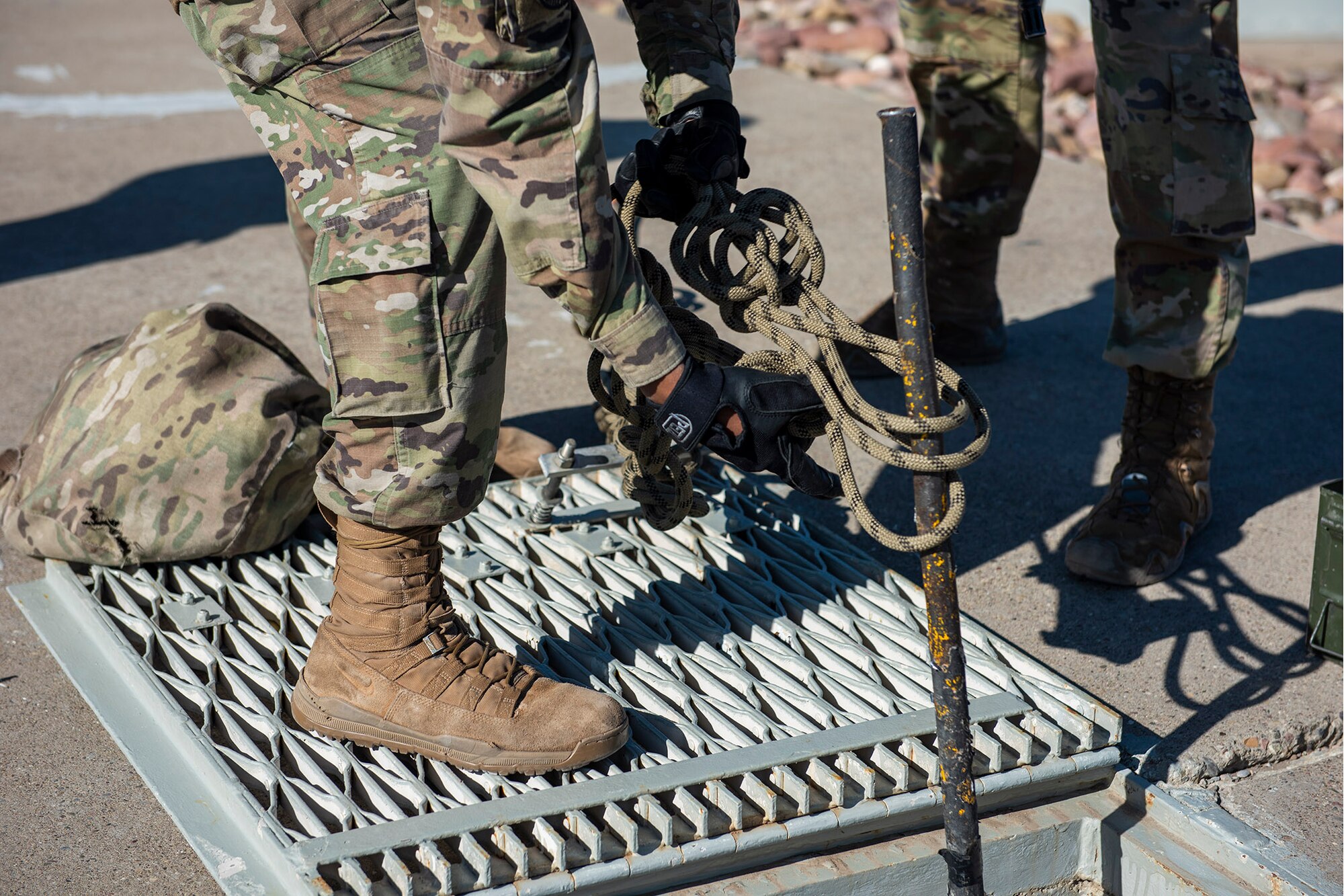 341st Missile Security Operations Squadron tactical response force members prepare wrap rope around a ladder in preparation to rappell during a training exercise April 19, 2022, at a launch facility near Malmstrom Air Force Base, Mont. TRF members assisted 841st Missile Security Forces Squadron personnel during the training exercise to improve interoperability in combat scenarios. (U.S. Air Force photo by Airman 1st Class Elijah Van Zandt)