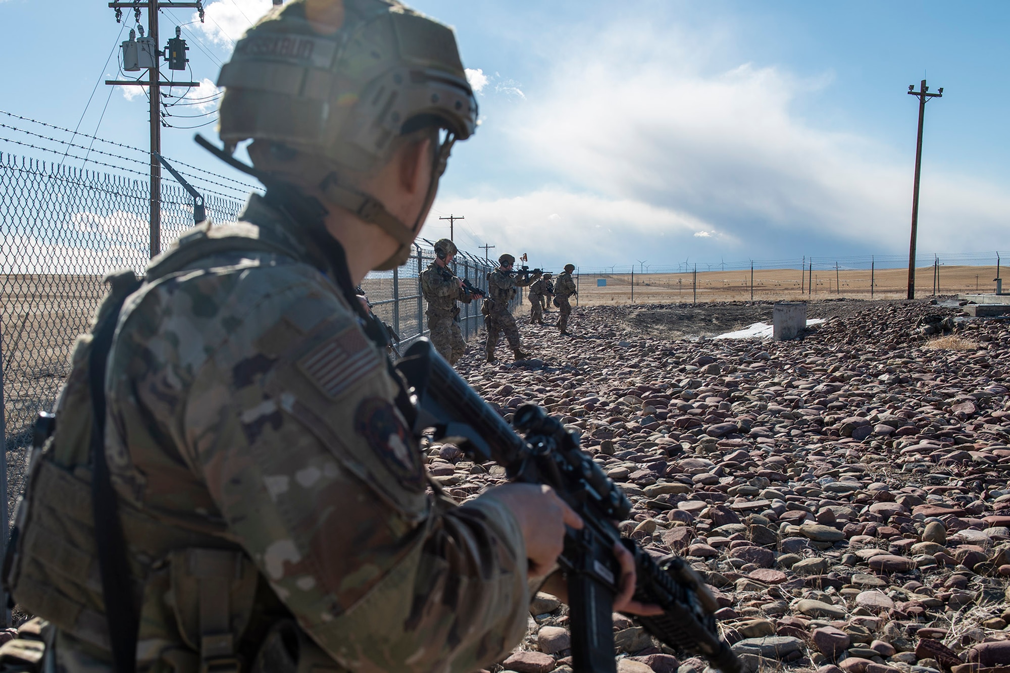 Defenders from the 841st Security Forces Squadron and the 341st Missile Security Operations Squadrons tactical response force, participate in a training exercise April 19, 2022, at a launch facility near Malmstrom Air Force Base, Mont. Members scouted the inside of the launch facility against simulated adversaries as part of the training exercise. The goal of the exercise was to improve teamwork and interoperability within the security forces group. (U.S. Air Force photo by Airman 1st Class Elijah Van Zandt)