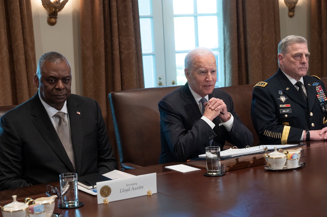 President Joe Biden, Secretary of Defense Lloyd J. Austin III and Army Gen. Mark A. Milley sit at table.