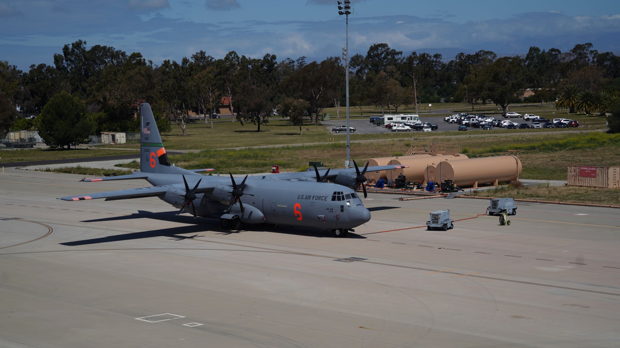 A U.S. Air Force C-130J Super Hercules MAFFS (Modular Airborne Firefighting System) aircraft assigned to the 146th Airlift Wing sits on the flight line in front of the newly constructed MAFFS pits at Channel Islands Air National Guard Station, Port Hueneme, California. April 21, 2022. The new fire-retardant ground tanks have increased the storage capability five-fold from a 10,000-gallon capacity to 50,000 gallons to accommodate more MAFFS aircraft and the U.S. Forest Service's Very Large Air Tankers (VLAT's) with water and fire retardant solution. (U.S. Air National Guard photo by Staff Sgt. Michelle Ulber)