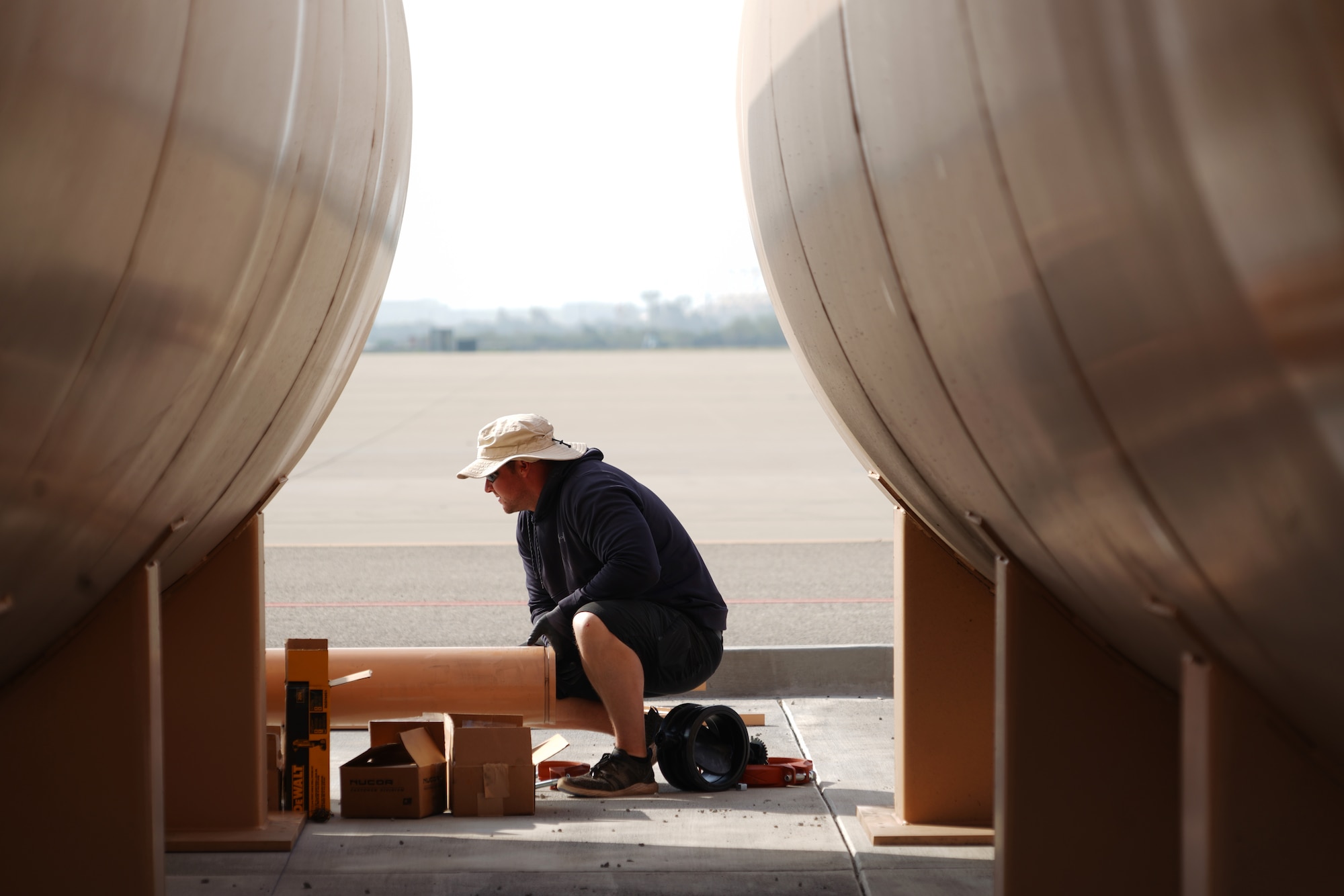 Ivan Ruhuhahsen, a service technician with Perimeter Solutions, works on the 146th Airlift Wing's new Modular Airborne Firefighting System (MAFFS) pits ground tanks at Channel Islands Air National Guard Station, Port Hueneme, California. March 3, 2022. The new fire-retardant ground tanks have increased the storage capability five-fold from a 10,000-gallon capacity to 50,000 gallons to accommodate more MAFFS aircraft and the U.S. Forest Service's Very Large Air Tankers (VLAT's) with water and fire retardant solution. (U.S. Air National Guard photo by Staff Sgt. Michelle Ulber)