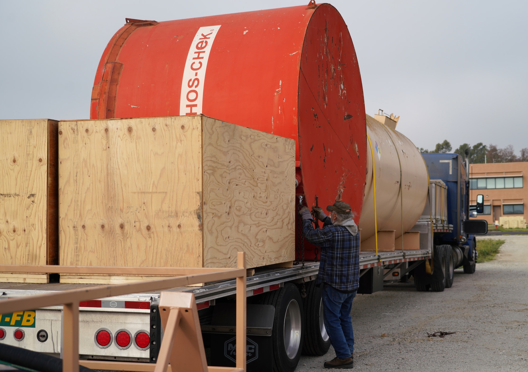 Darrin Hutchison, an area manager with Perimeter Solutions, secures the previously used MAFFS (Modular Airborne Firefighting System) fire retardant ground tank to a truck at the Channel Island Air National Guard Station, Port Hueneme, California. March 3, 2022. The new fire-retardant ground tanks have increased the storage capability five-fold from a 10,000-gallon capacity to 50,000 gallons to accommodate more MAFFS aircraft and the U.S. Forest Service's Very Large Air Tankers (VLAT's) with water and fire retardant solution. (U.S. Air National Guard photo by Staff Sgt. Michelle Ulber)