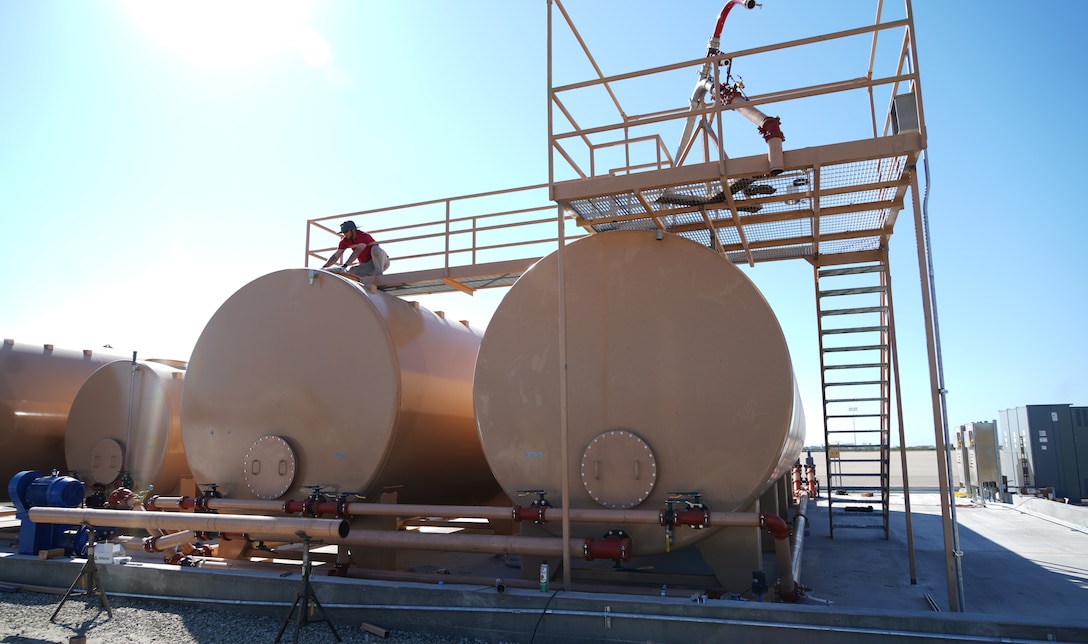 Levi Mello, a service technician with Perimeter Solutions, tightens a valve on the 146th Airlift Wing's new Modular Airborne Firefighting System (MAFFS) pits ground tanks at Channel Island Air National Guard Station, Port Hueneme, California. March 9, 2022. The new fire-retardant ground tanks have increased the storage capability five-fold from a 10,000-gallon capacity to 50,000 gallons to accommodate more MAFFS aircraft and the U.S. Forest Service's Very Large Air Tankers (VLAT's) with water and fire retardant solution. (U.S. Air National Guard photo by Staff Sgt. Michelle Ulber)