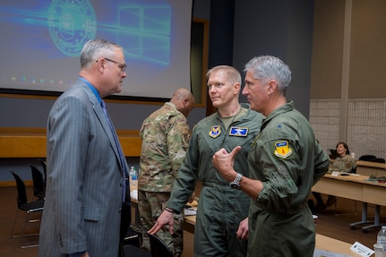 Randall Robinson, left, executive deputy to the commanding general of the Army Installation Management Command, talks with Col. Paul Birch and Brig. Gen. Jeremy T. Sloane, the incoming and outgoing commanders of Joint Base Marianas, Guam, at the Air Force Installation and Mission Support Center’s Joint Base Commanders Summit at Joint Base San Antonio-Lackland, Texas, April 20, 2022. The summit included discussions between joint base leaders, Office of the Secretary of Defense, Army Installation Management Command and AFIMSC leadership regarding unique installation and mission support issues at their bases. (U.S. Air Force photo by Malcolm McClendon).