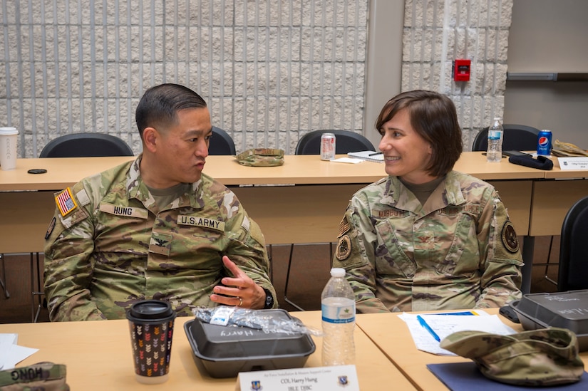 Army Col. Harry Hung, vice commander of the 633rd Air Base Wing at Joint Base Langley-Eustis, Virgina, and Air Force Col. Lisa Mabbutt with the 633rd Mission Support Group, discuss a topic at the at the Air Force Installation and Mission Support Center’s Joint Base Commanders Summit at Joint Base San Antonio-Lackland, Texas, April 20, 2022. The summit included discussions between joint base leaders, Office of the Secretary of Defense, Army Installation Management Command and AFIMSC leadership regarding unique installation and mission support issues at their bases. (U.S. Air Force photo by Malcolm McClendon).