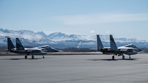 A photo of 2 F-15 Eagles sitting on the flight line.